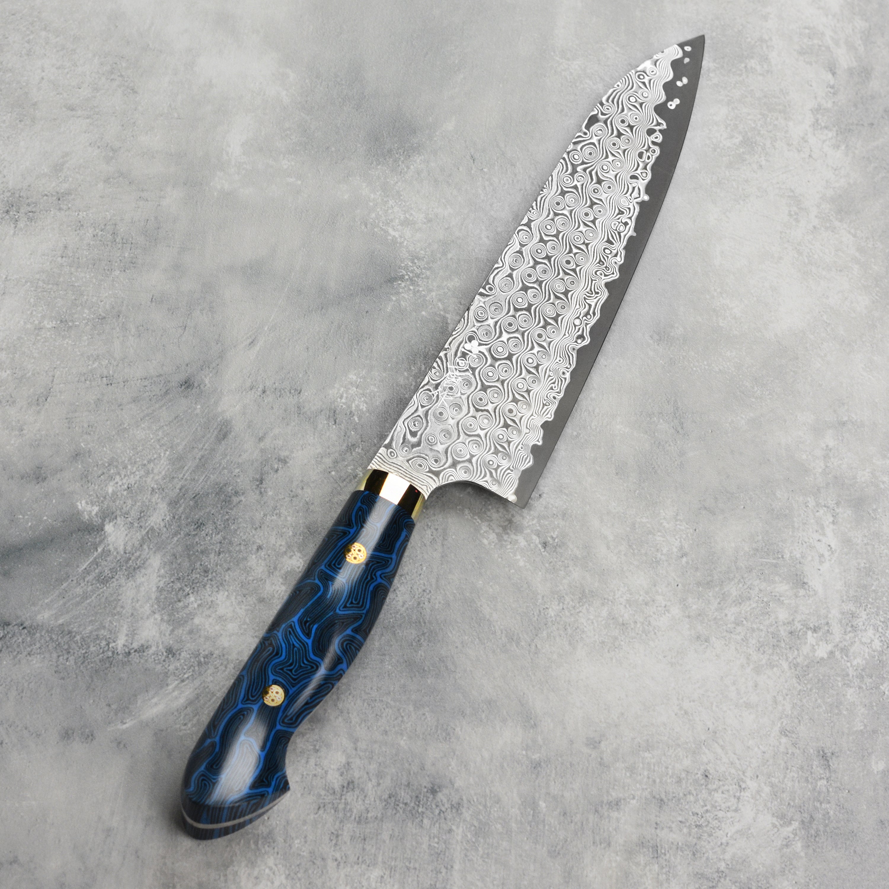 Close-up of the Damascus pattern and sharp edge of the gyuto knife