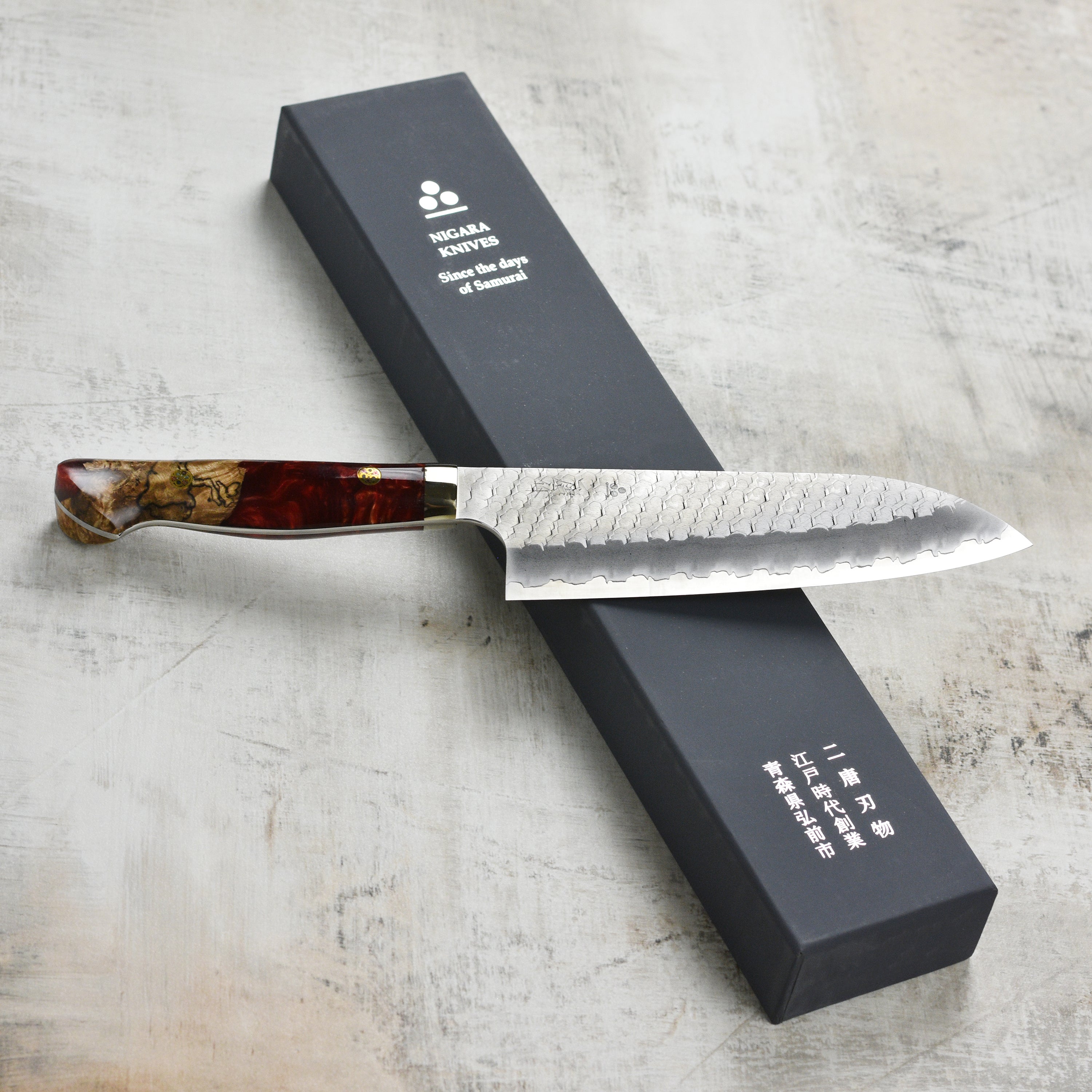 Nigara SG2 Migaki Tsuchime 7-inch Santoku knife with crimson handle, top view
