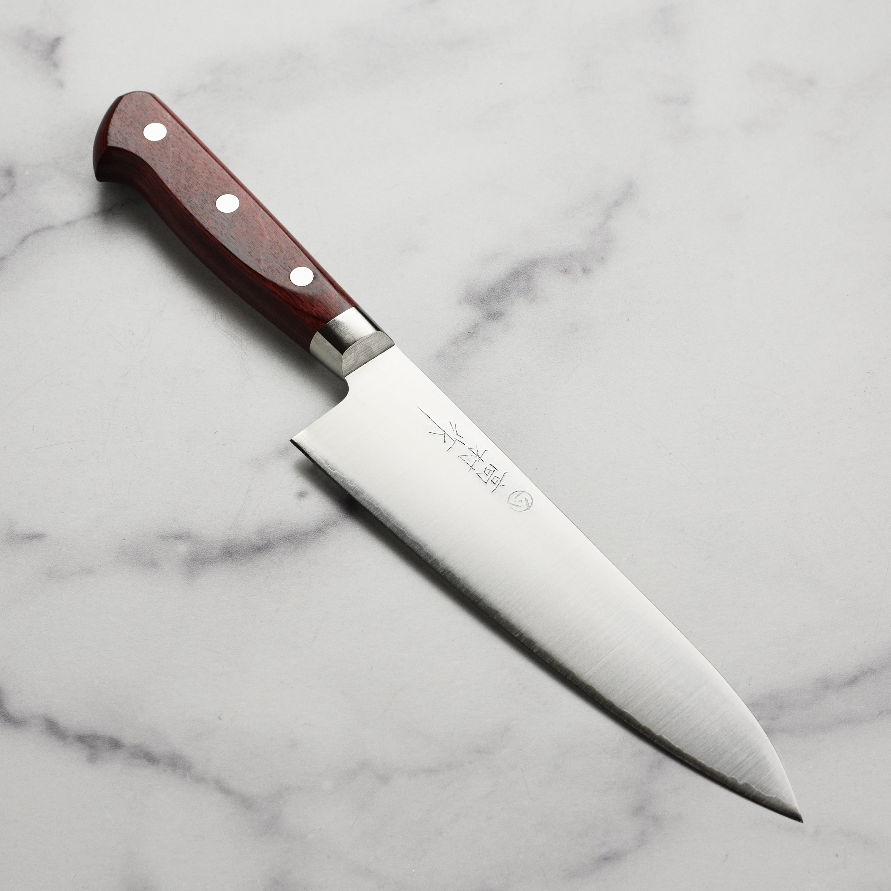Takamura SG2 Gyuto knife showcasing its sharp 7-inch blade from a side angle