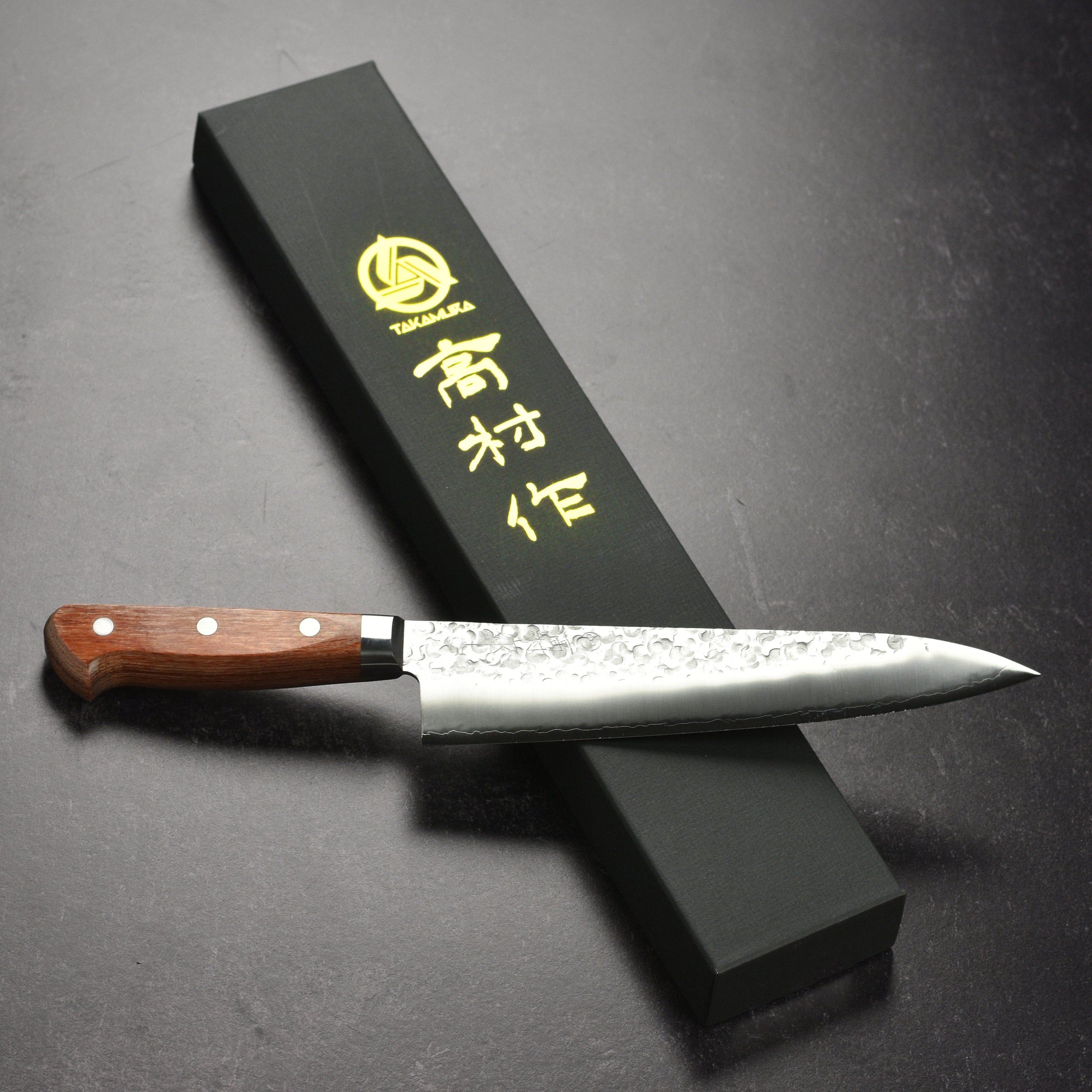 Close-up of the Takamura Chromax Tsuchime Gyuto Knife blade, illustrating the craftsmanship and tsuchime texture.