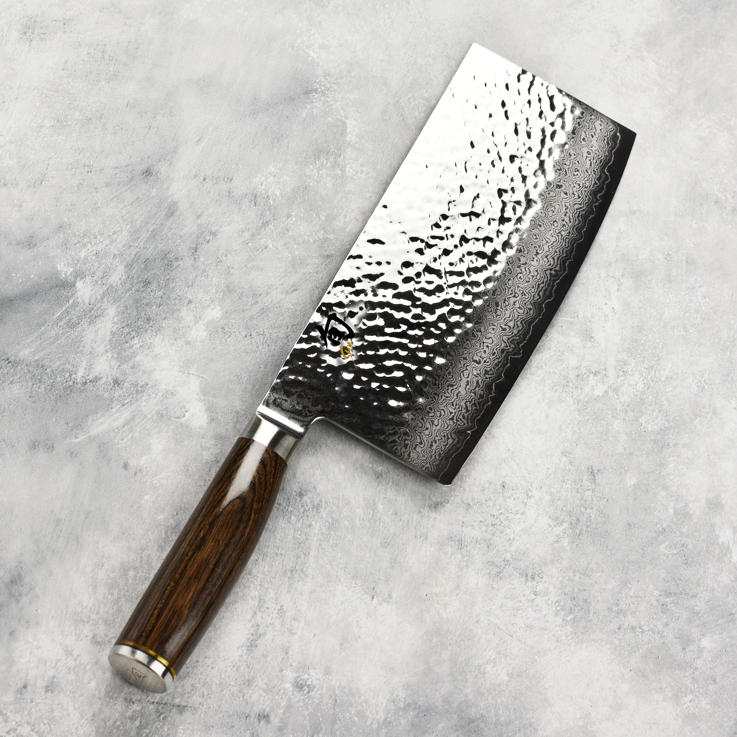 Chef using vegetable cleaver for chopping vegetables in a modern kitchen