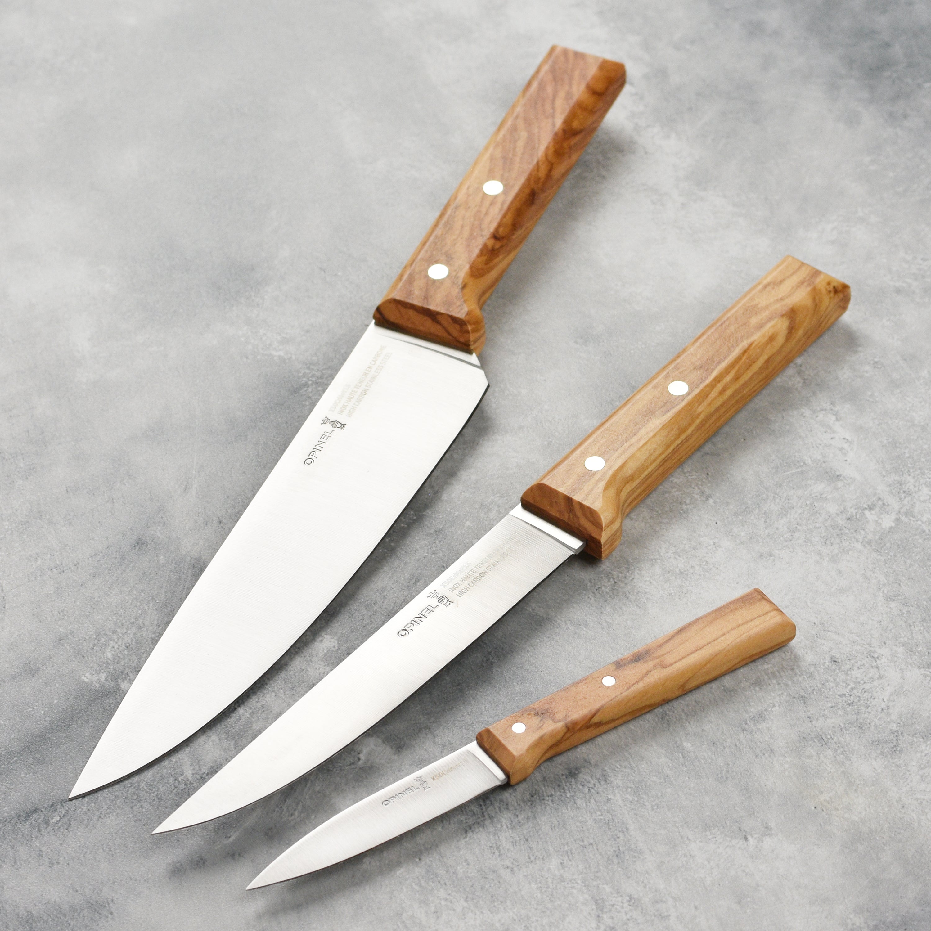 Close-up of the olivewood handle on the chef knife displaying its rich grain.
