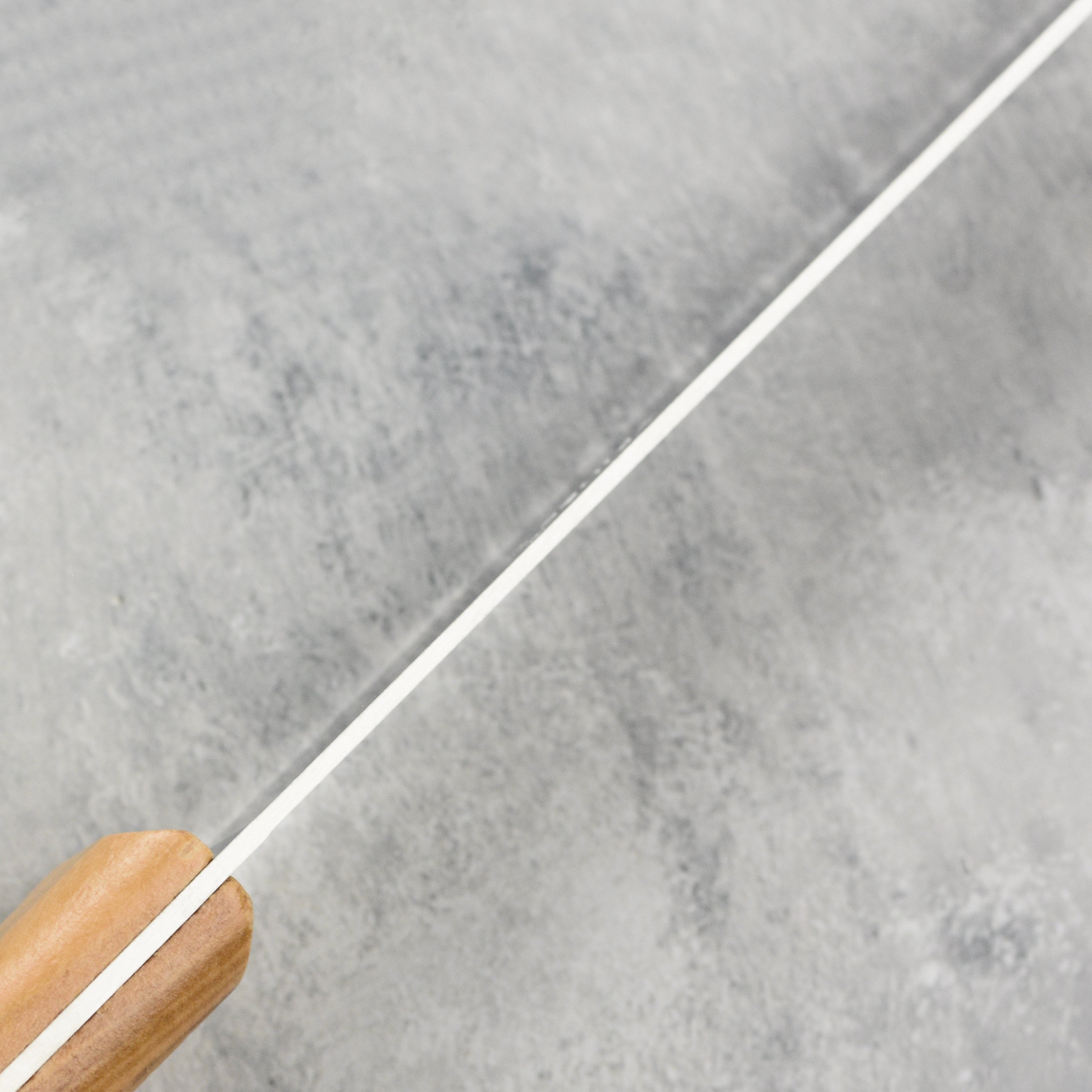 Chef using the olivewood handle knife for slicing fresh vegetables.