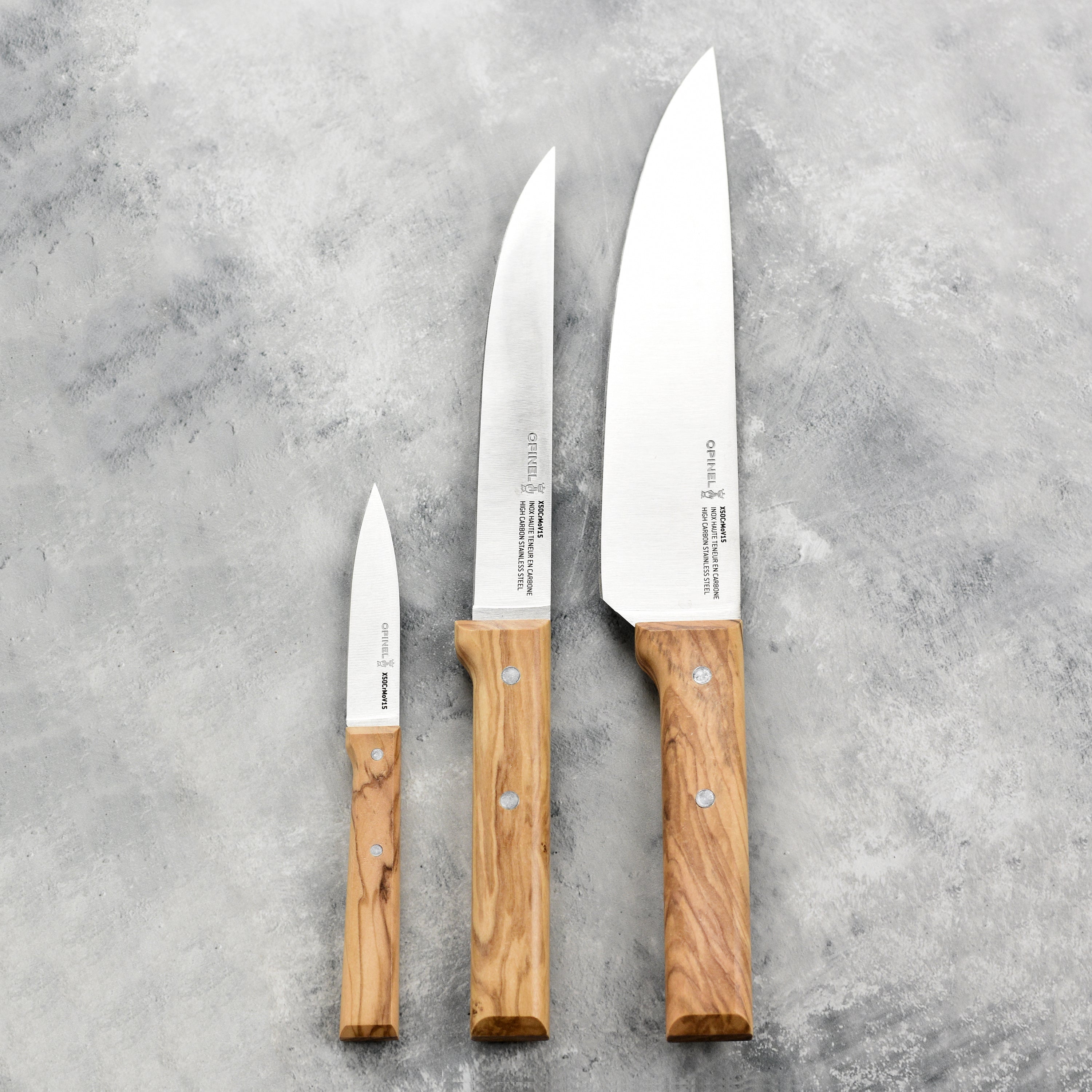 Chef using the olivewood handle knife for slicing fresh vegetables.