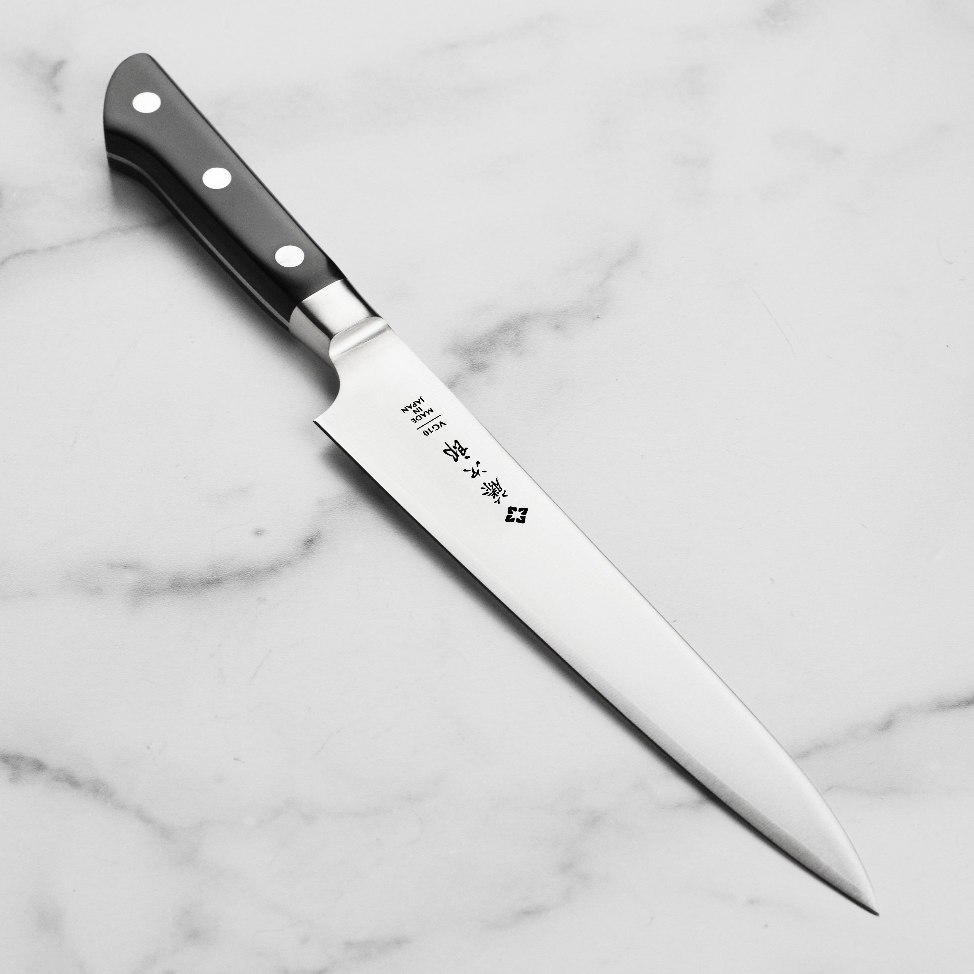 Tojiro Classic carving knife with a sleek design, perfect for precise cuts.