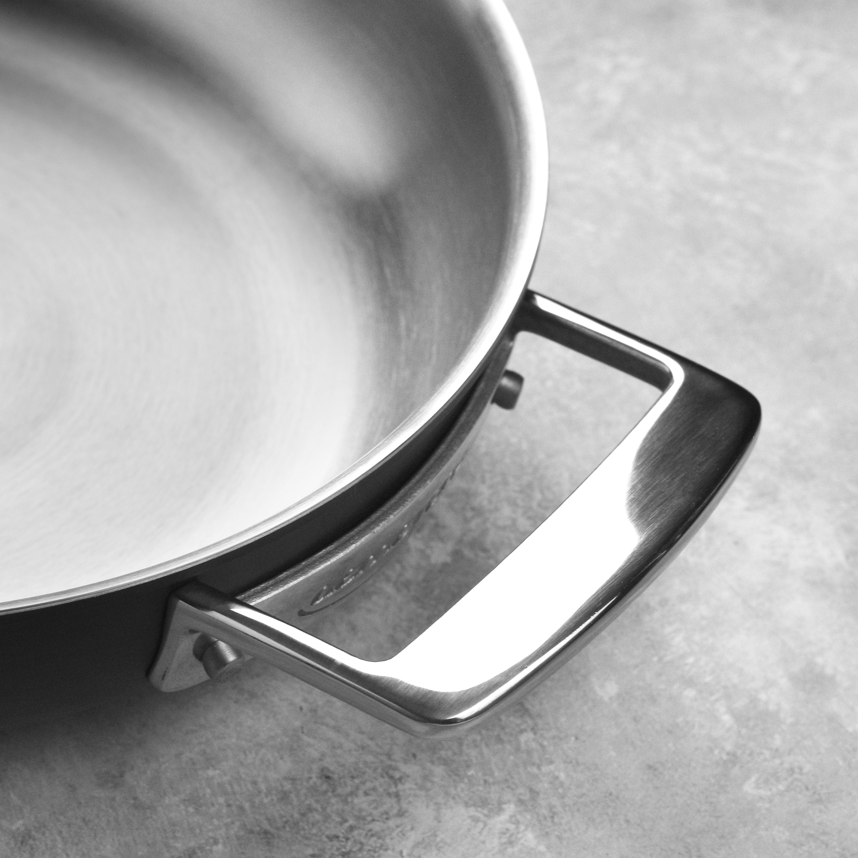 Demeyere fry pan being used for grilling vegetables over charcoal flames