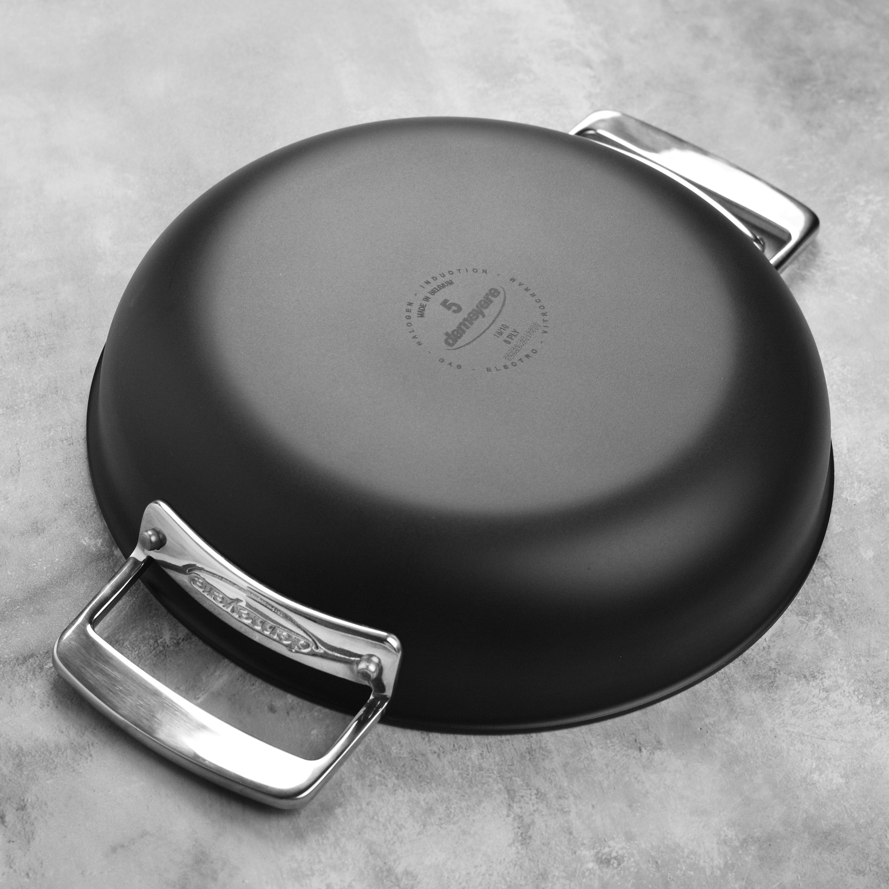 Top-down angle of double handle fry pan placed on induction cooktop