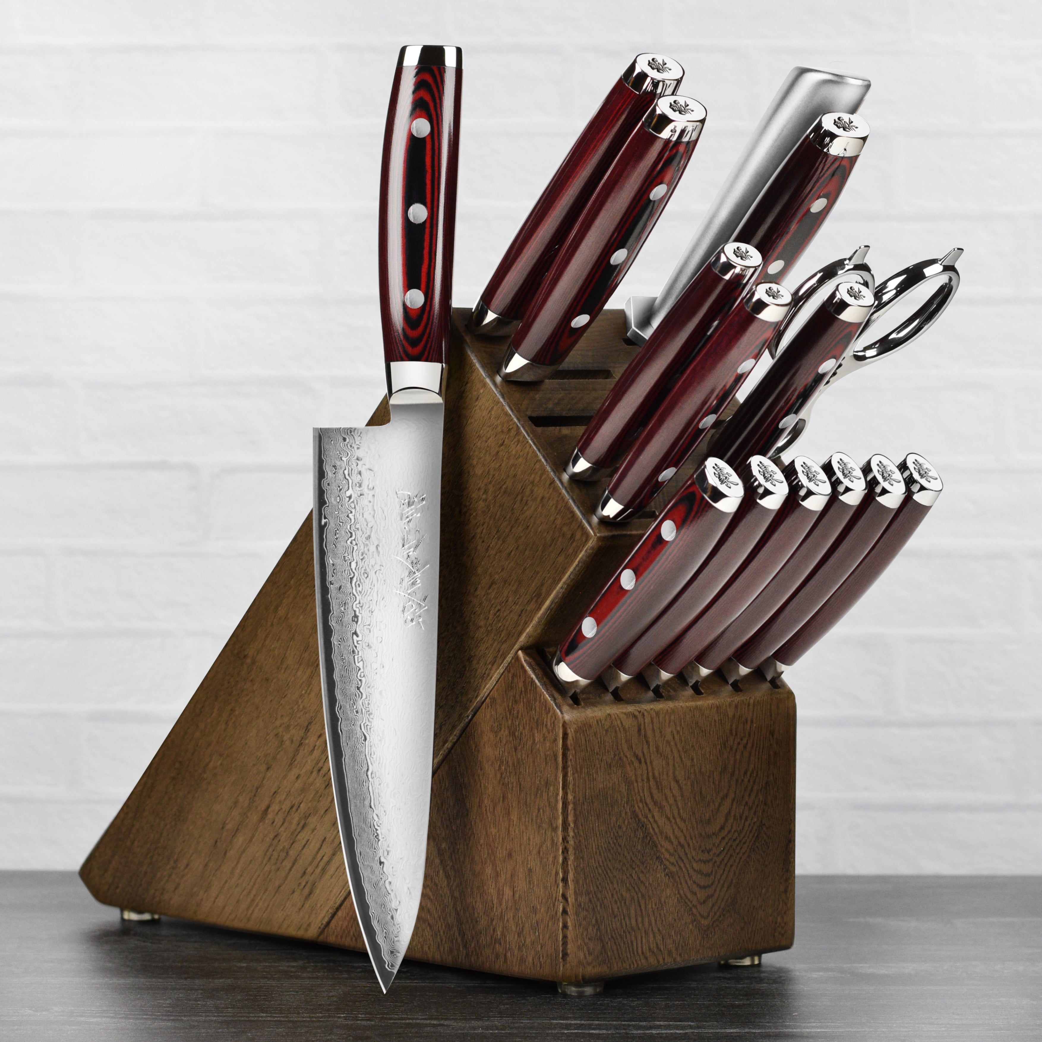 Yaxell Super Gou Japanese knife set with dark ash block and blades highlighting layered steel construction