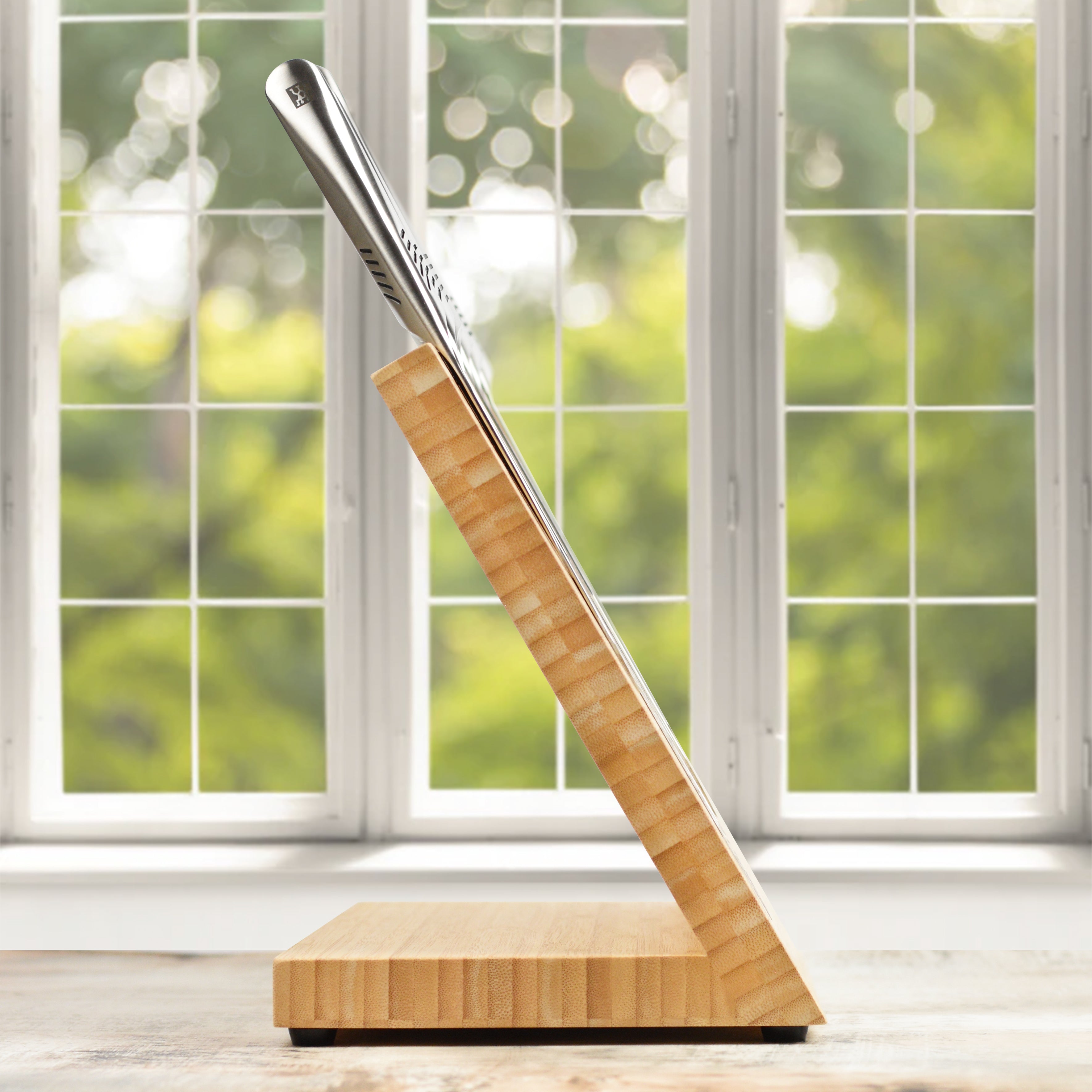 Japanese chef knife set with bamboo handles and stainless steel blades on a cutting board