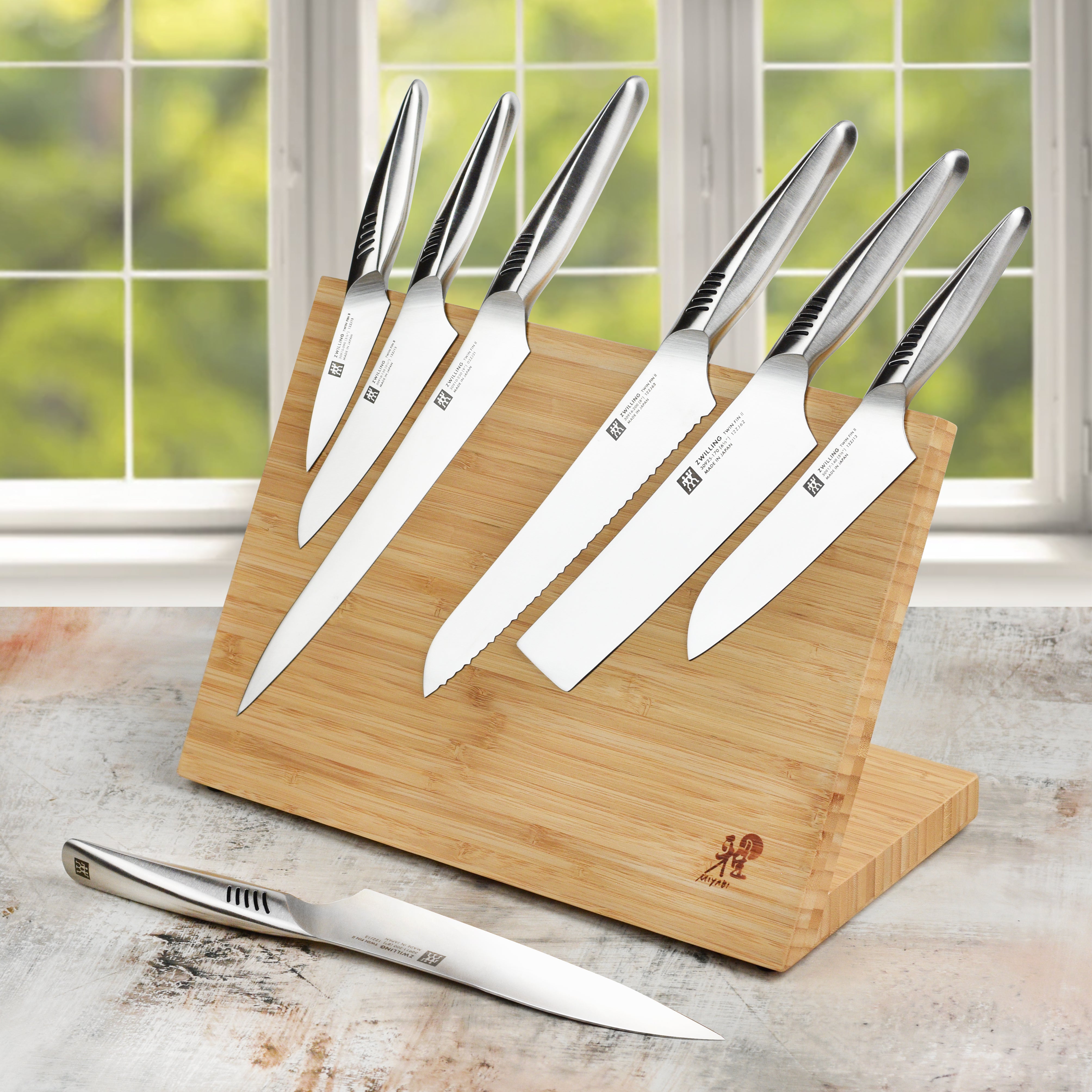 Kitchen scene showing the complete bamboo knife set with magnetic display