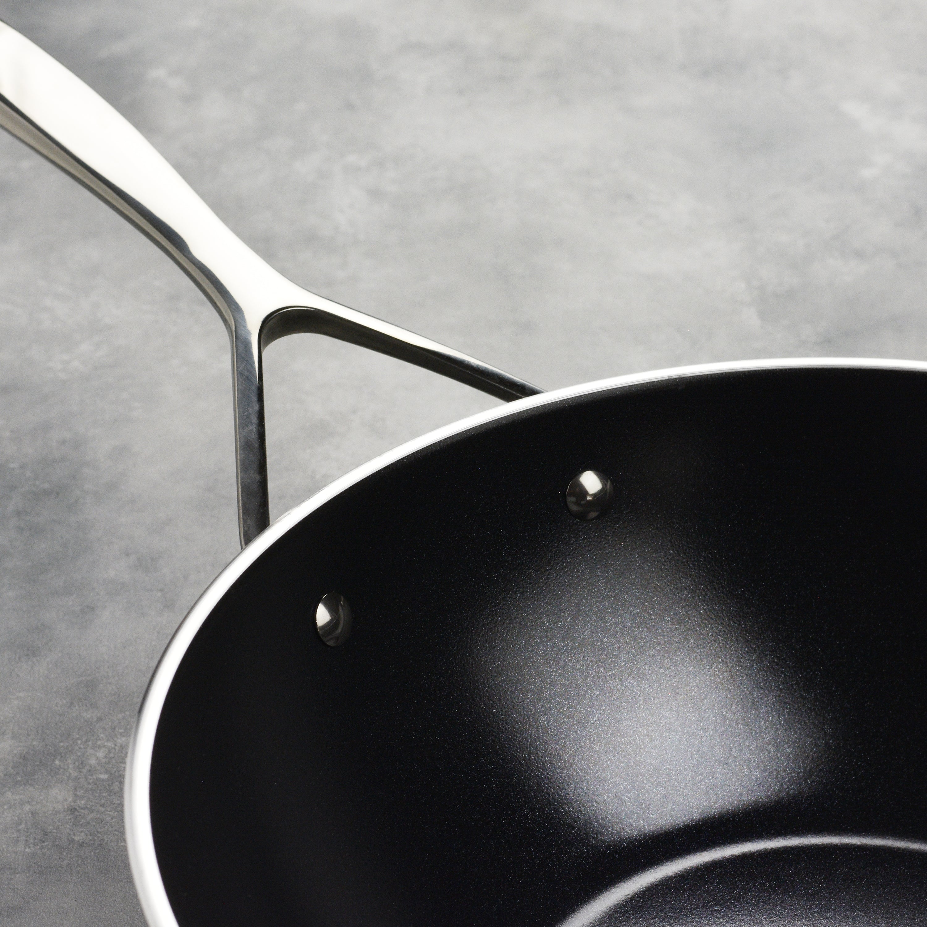 Close-up of nonstick ceramic coating resisting scratches from metal utensil use