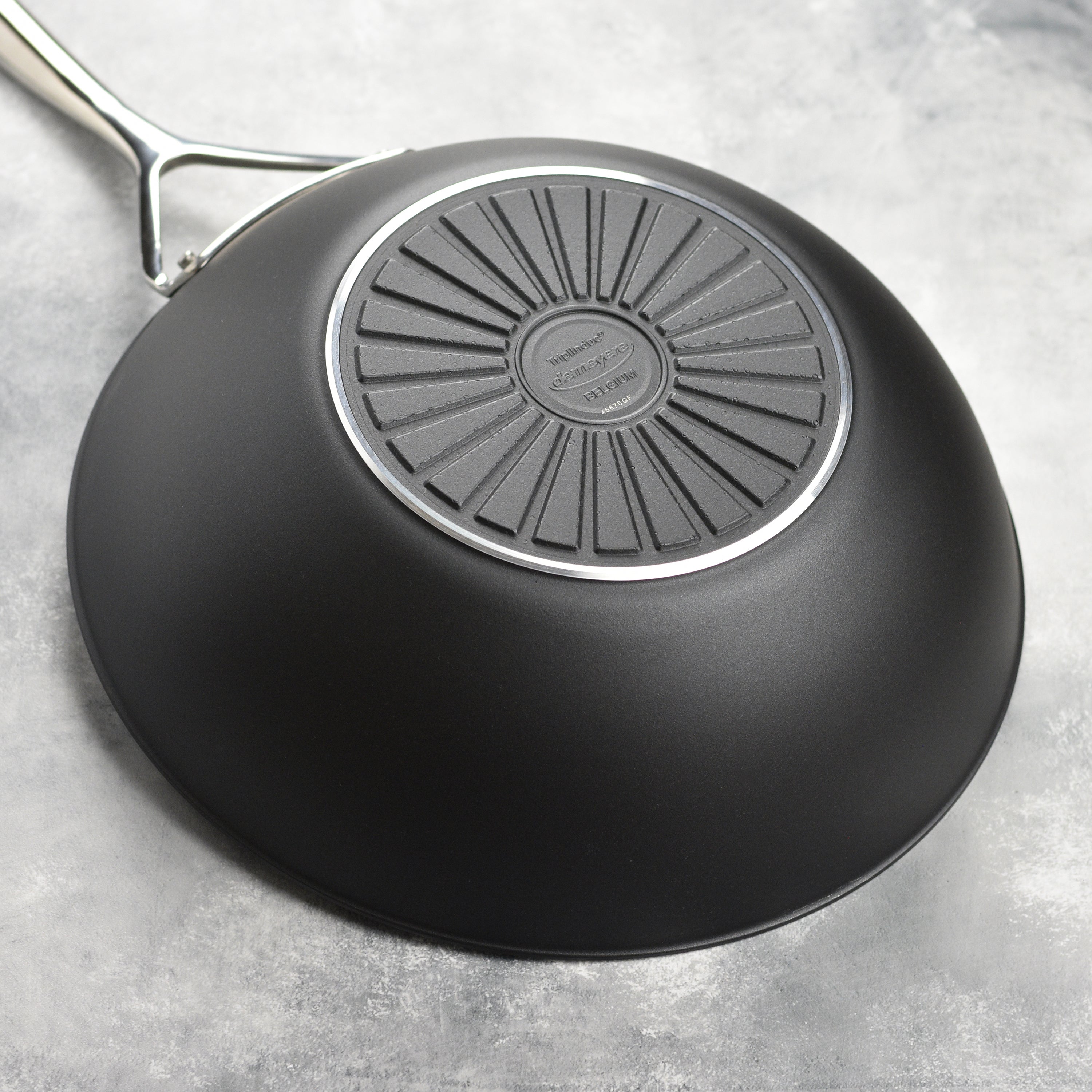 Overhead view of ceramic wok on induction cooktop, showcasing even heat distribution