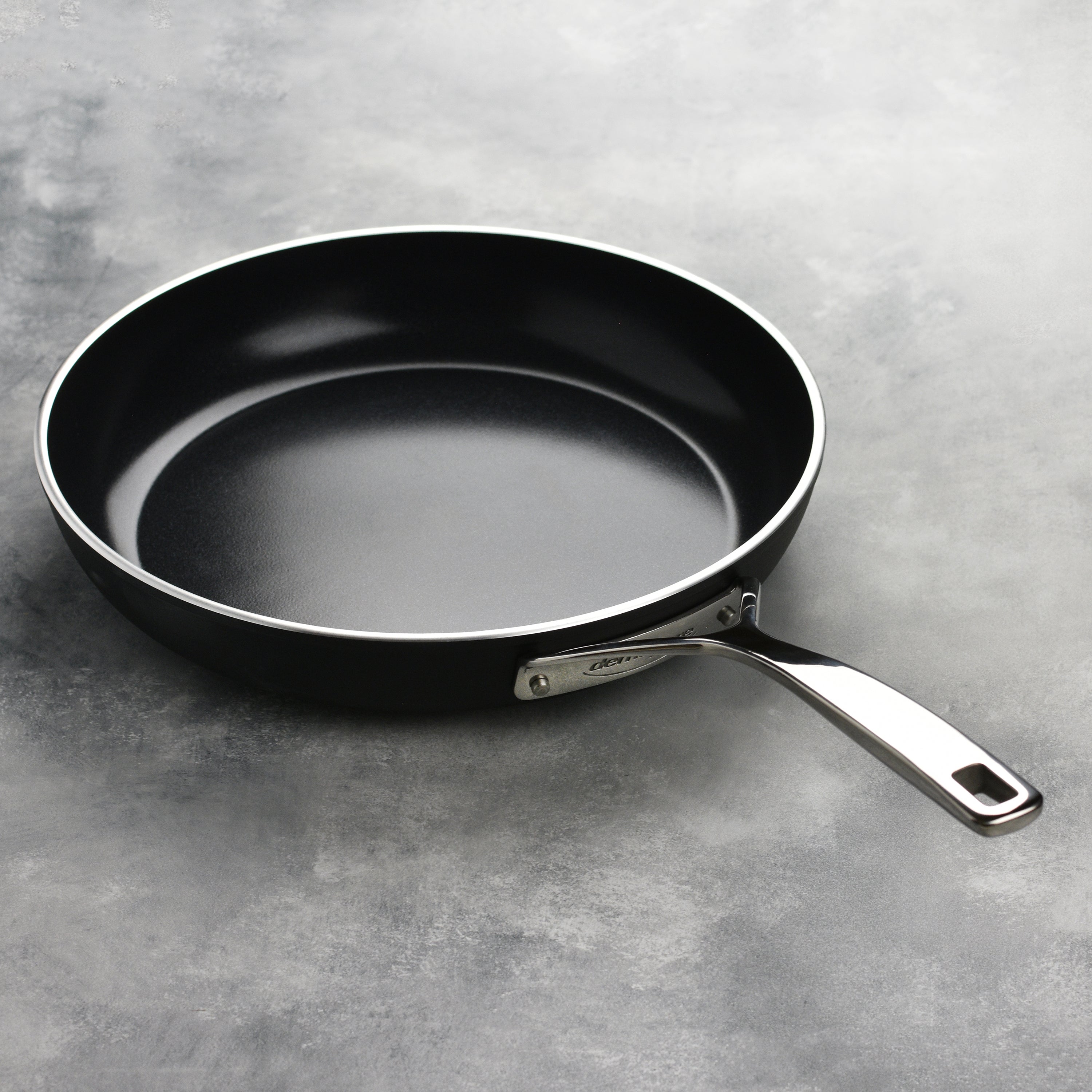 Oven-safe ceramic frying pan with stainless steel handles, perfect for versatile cooking