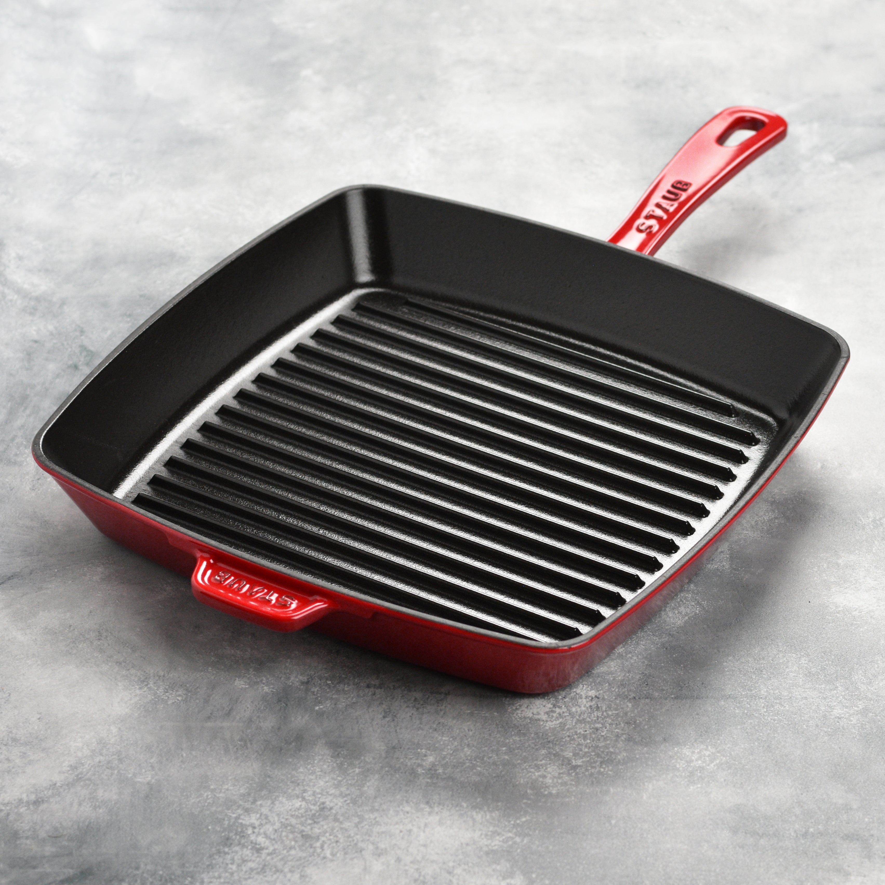Close-up of the Staub grill pan on a stovetop, demonstrating its versatility for grilling.