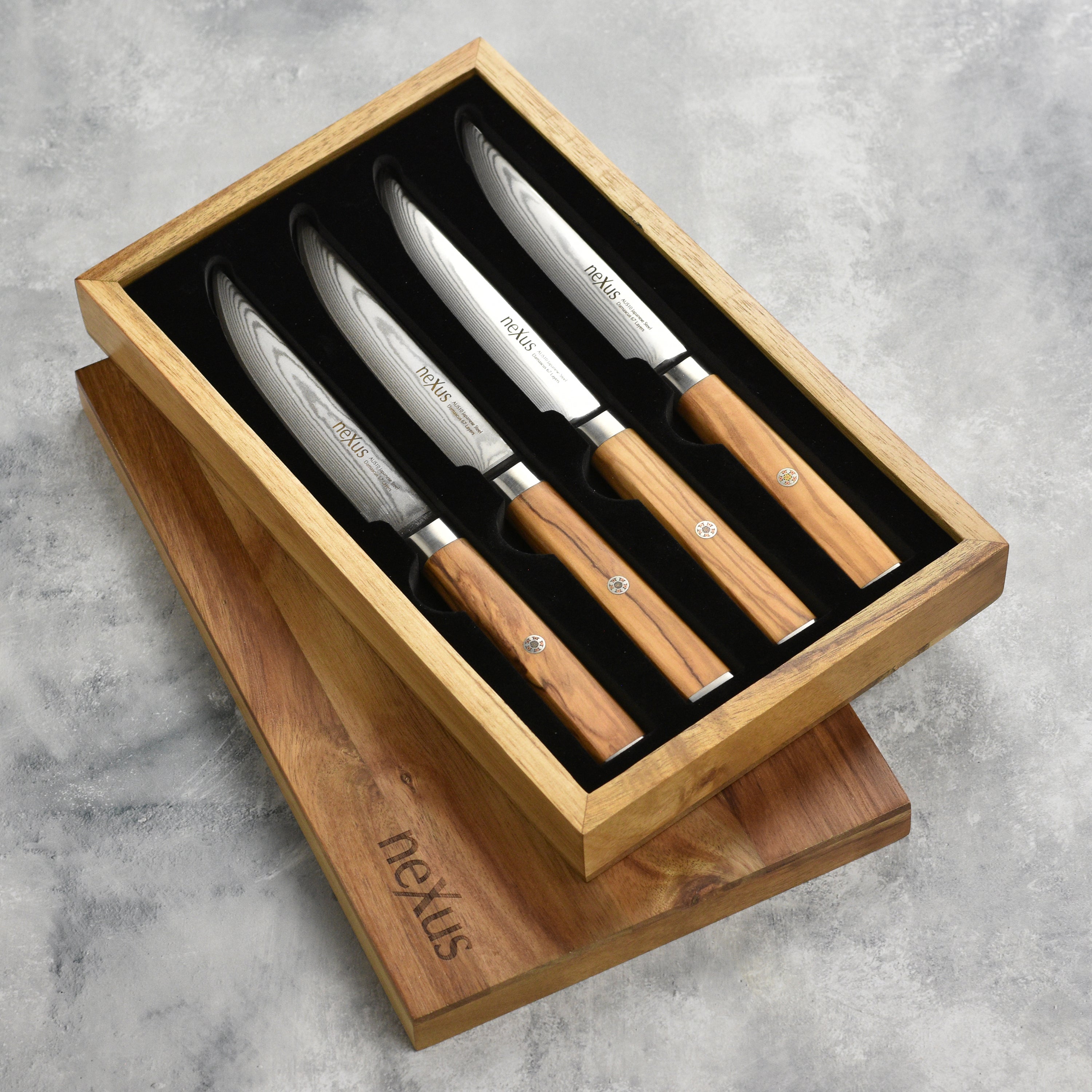 Premium olive wood steak knives displayed elegantly on a wooden table.