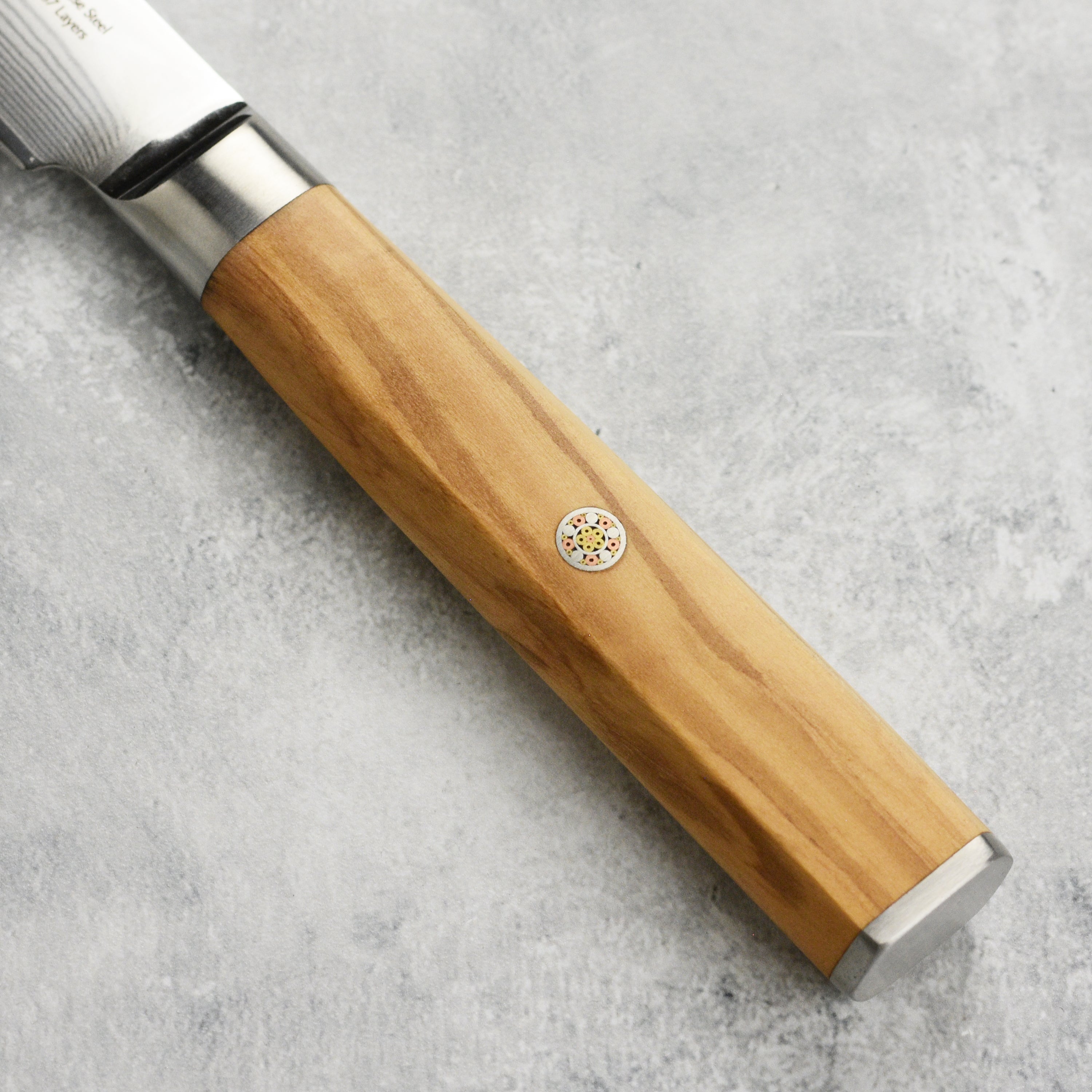 Close-up of the 67-layer damascus blades showcasing fine craftsmanship.
