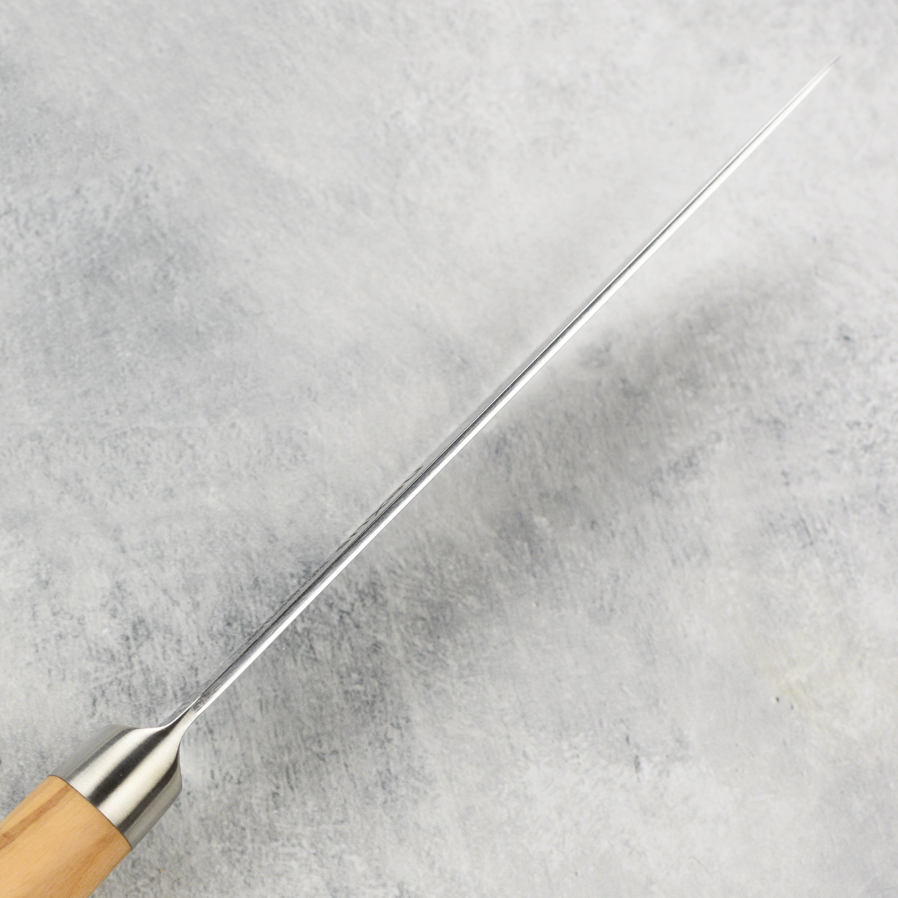 Premium olive wood steak knives displayed elegantly on a wooden table.