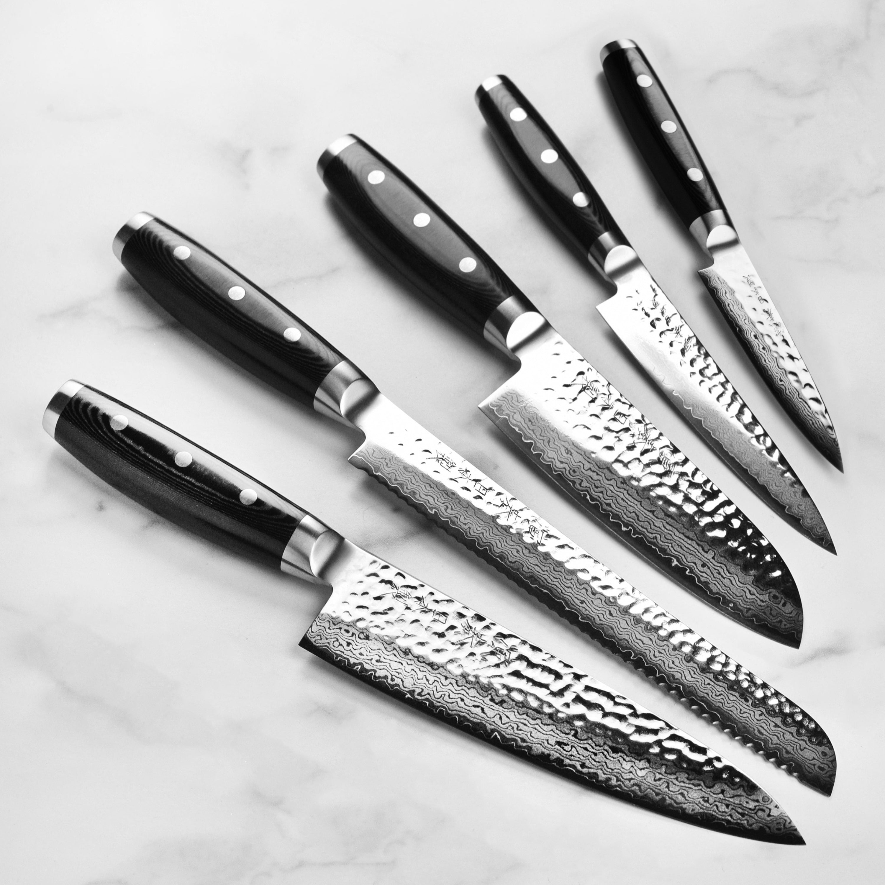 Close-up of the VG-10 steel blade illustrating its sharp edge and hammered finish.