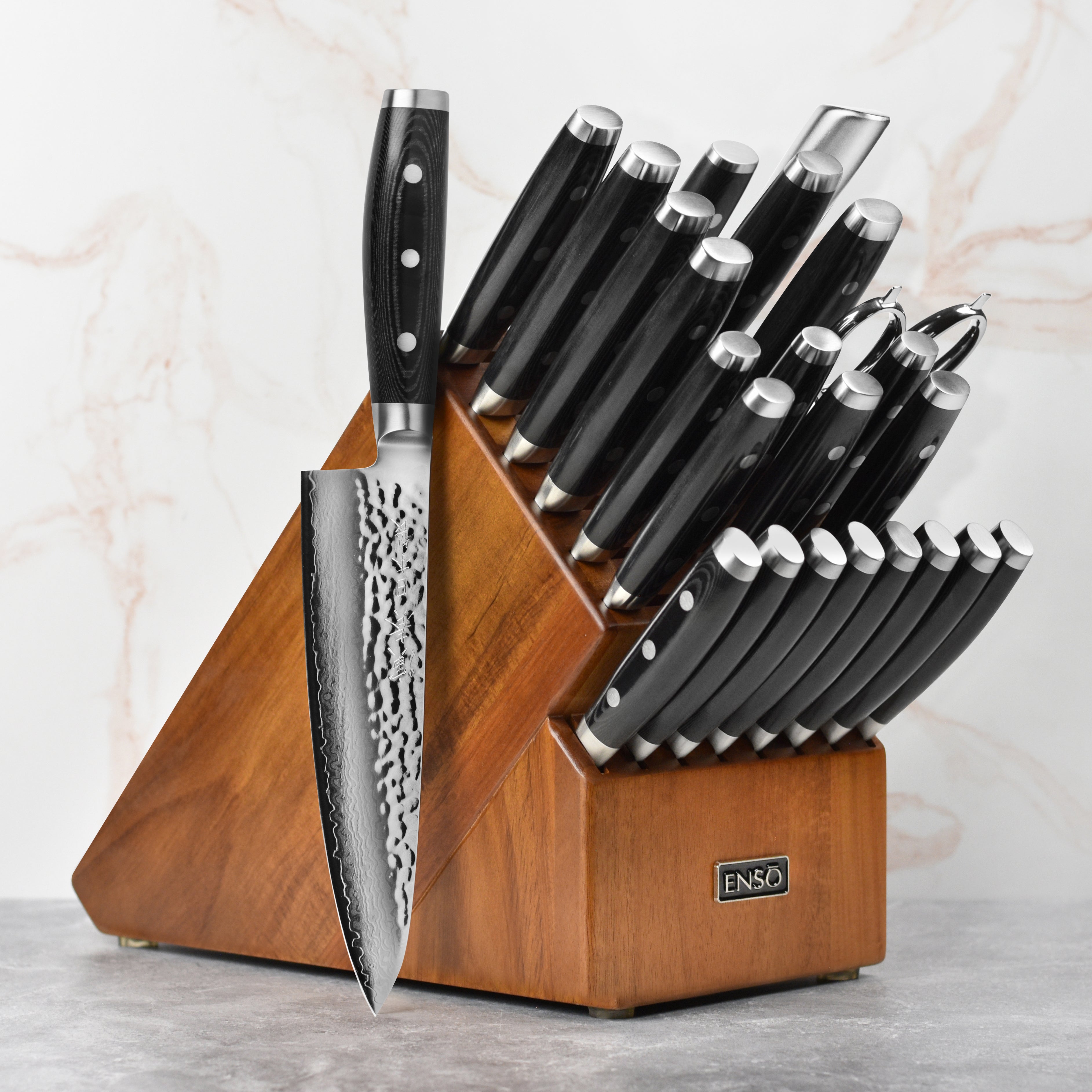 Enso HD Damascus knife set displayed with a wooden cutting board and fresh vegetables