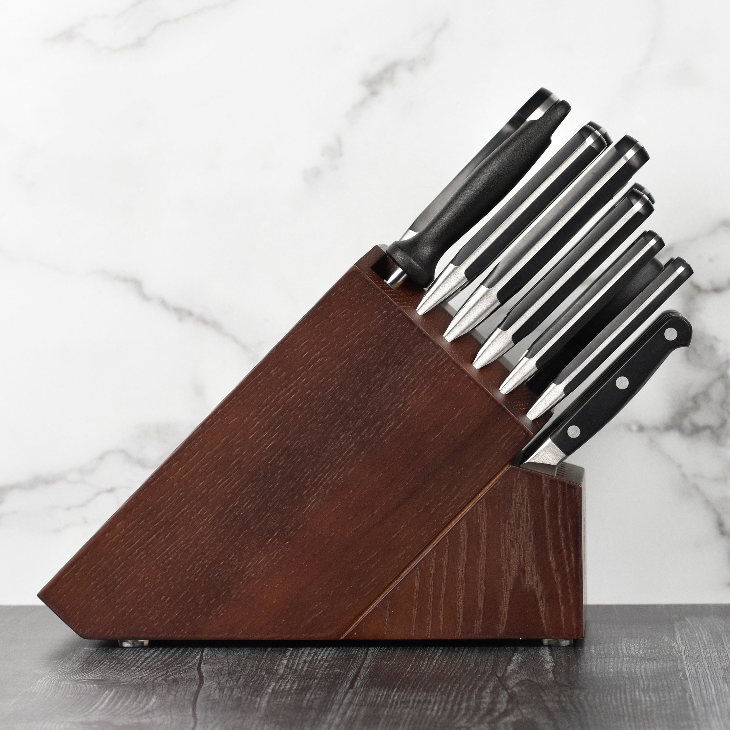 Close-up of the Zwilling high carbon steel knives with a focus on the ergonomic handle and blade finish.