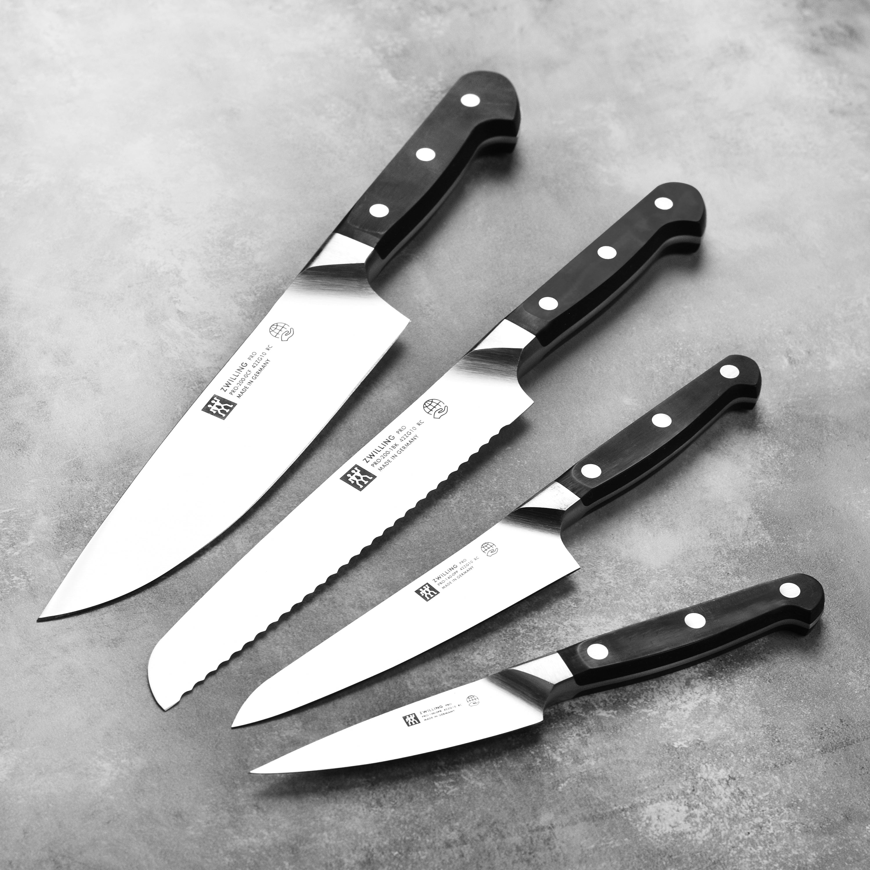 Chef using Zwilling Pro knife for precise slicing on a cutting board