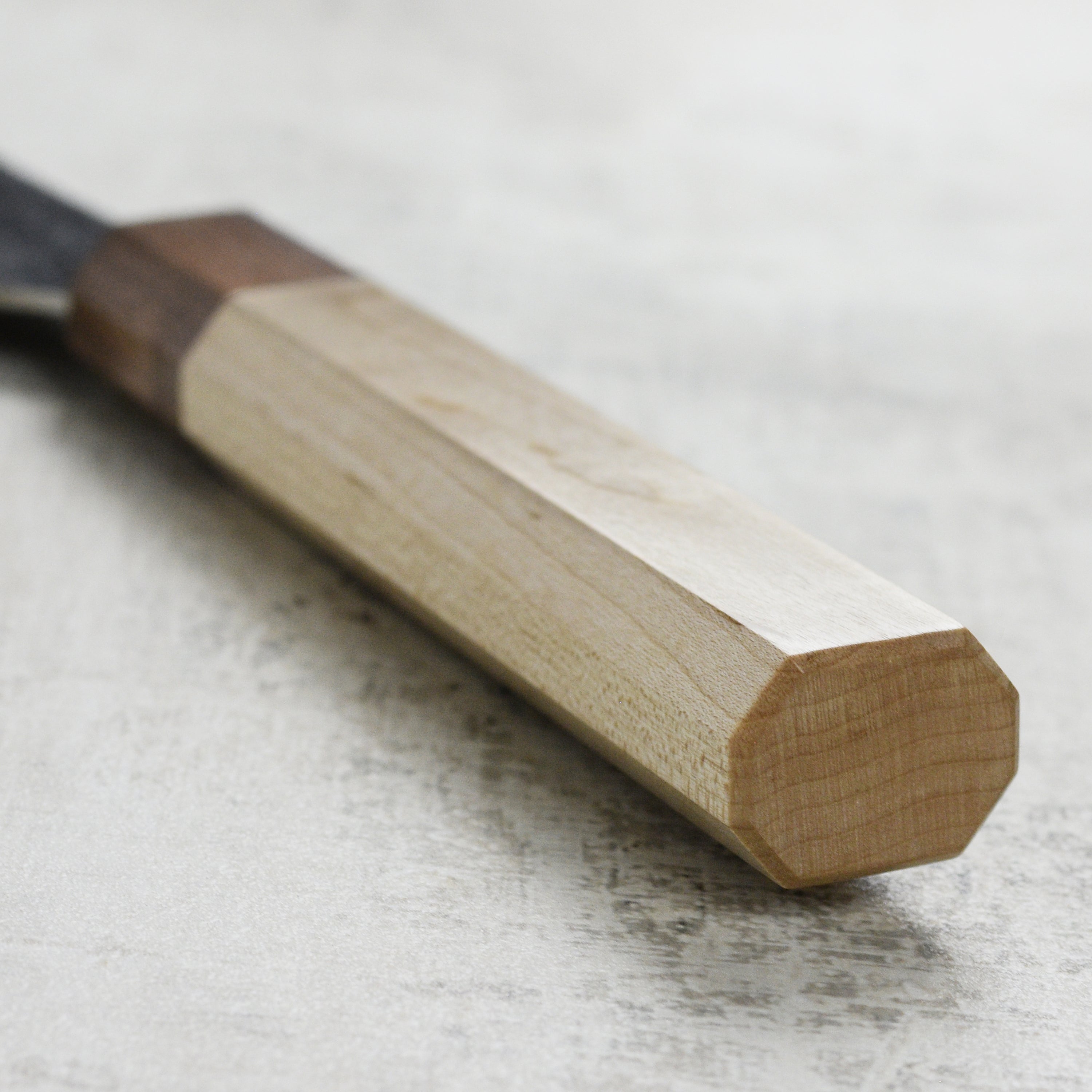 Professional chef using the Kurosaki Gyuto knife for precise vegetable slicing.