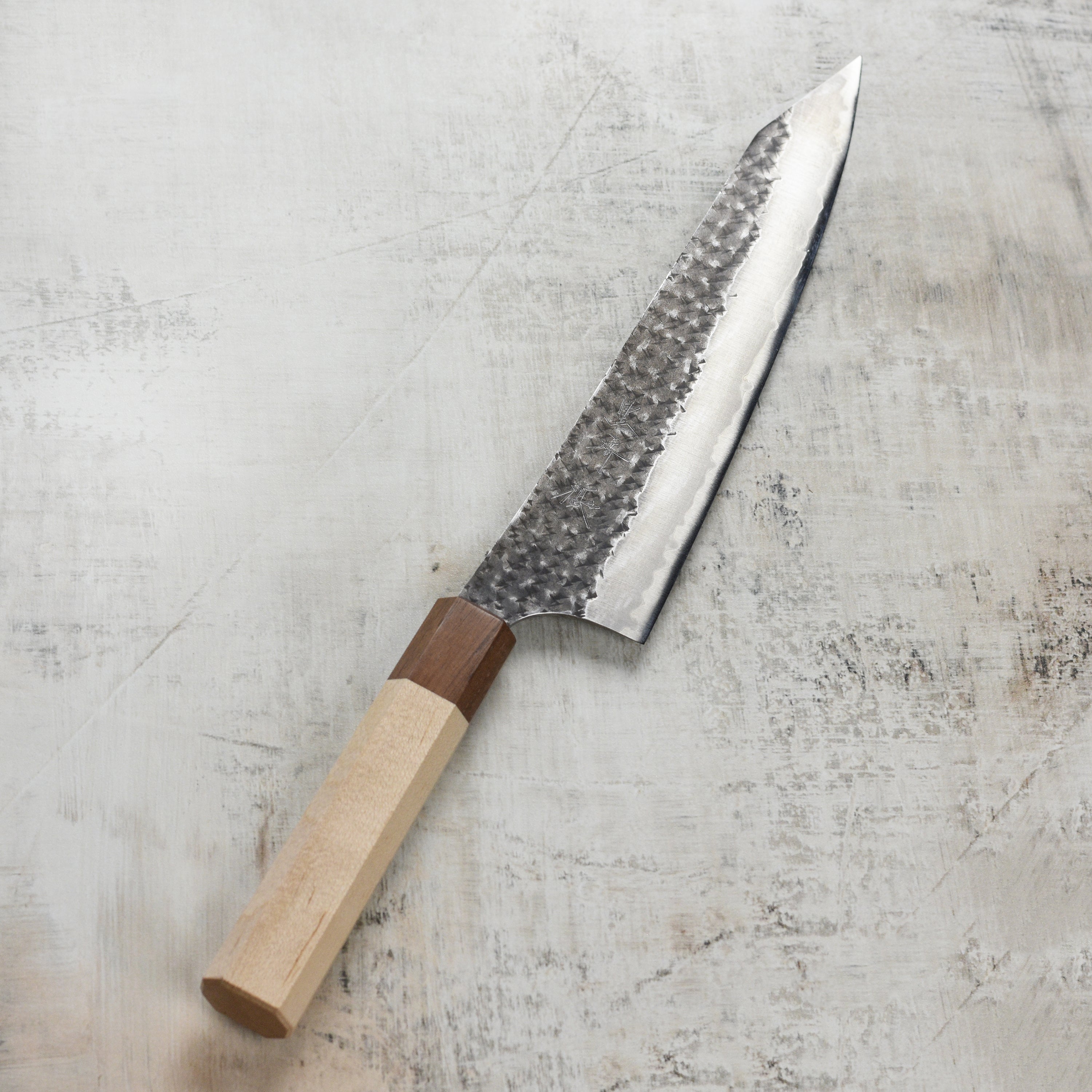 Professional chef using the Kurosaki Gyuto knife for precise vegetable slicing.