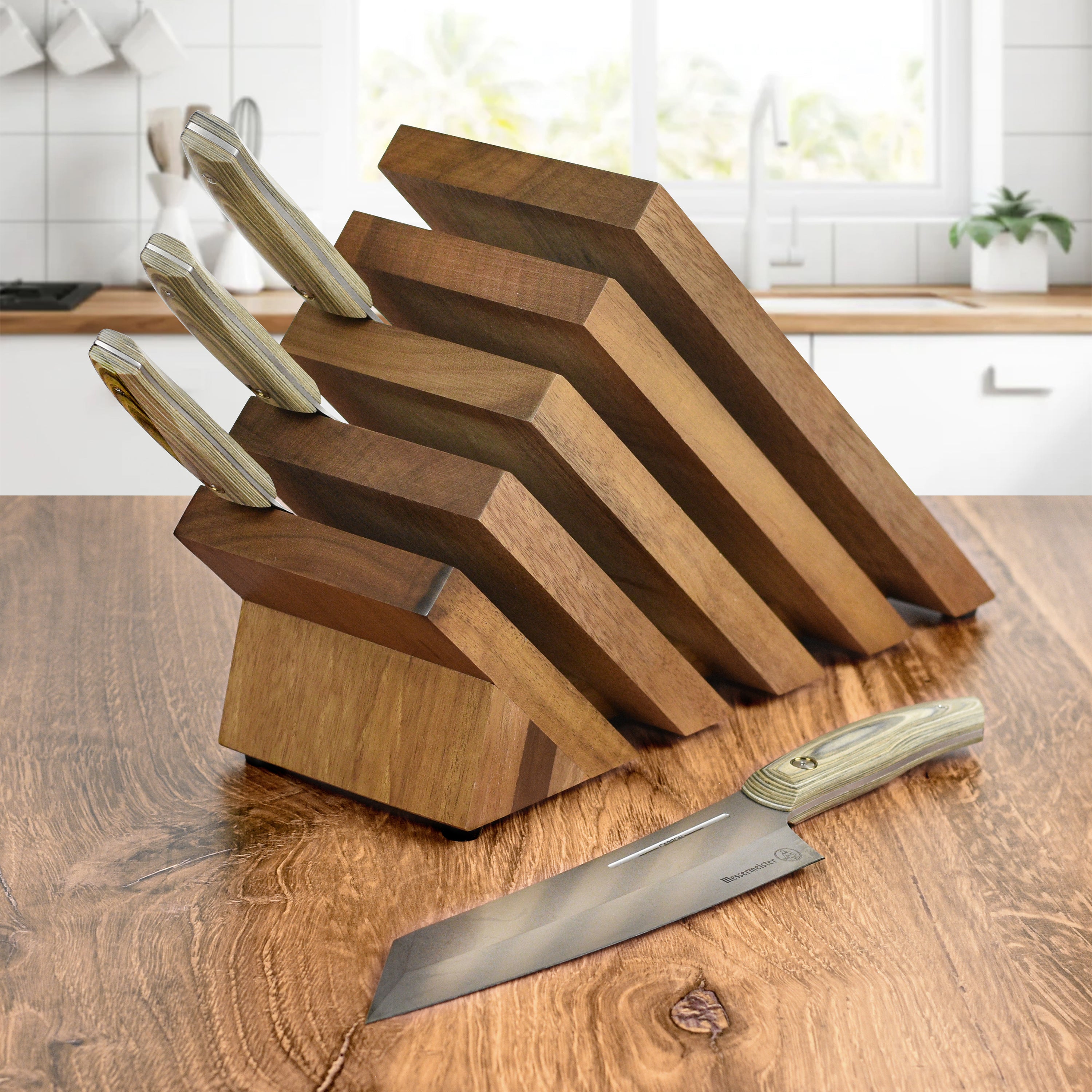 Messermeister 5-piece carbon steel knife set displayed on a wooden cutting board.