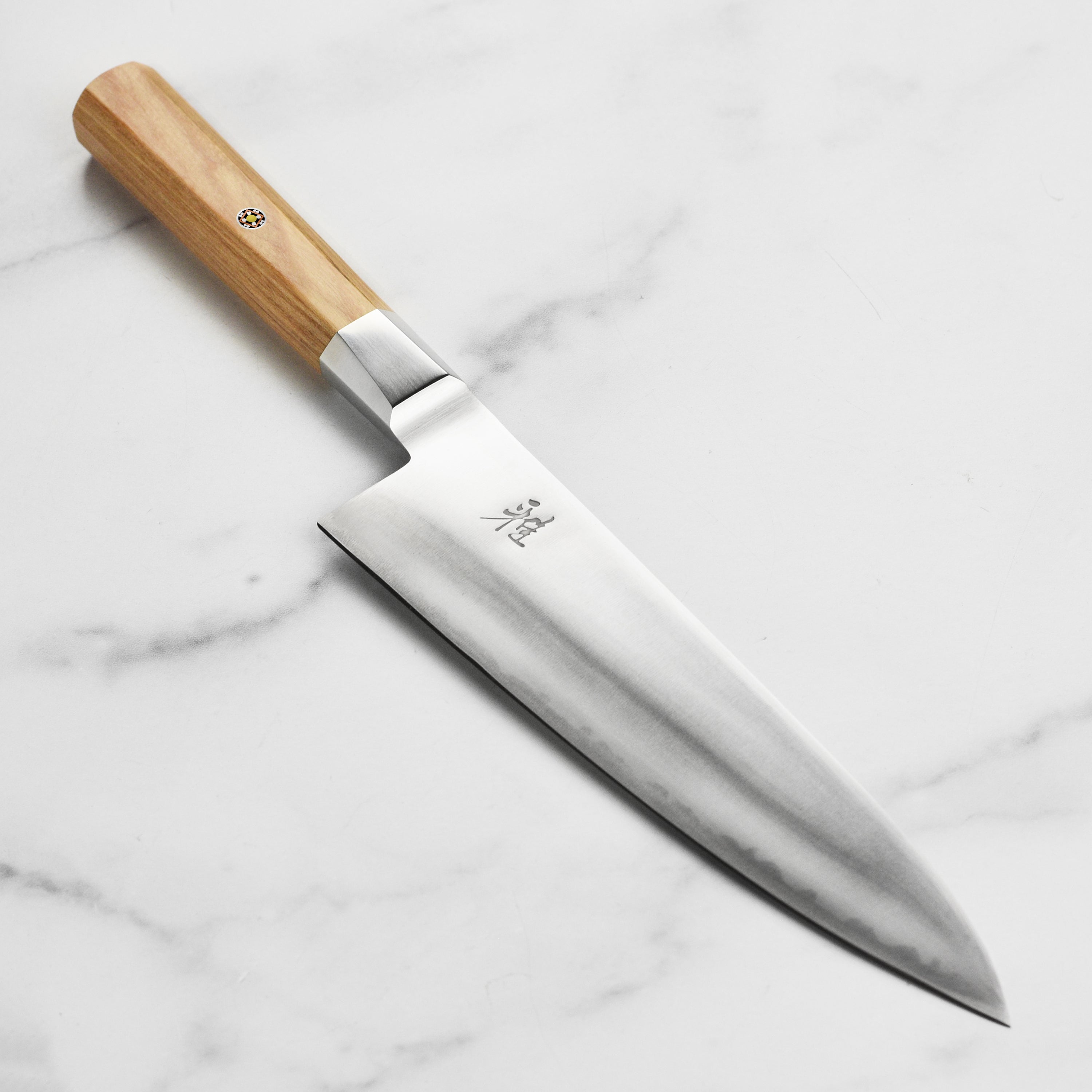 Miyabi Koya 8-inch chef's knife blade detail highlighting the sharp edge and engraved logo