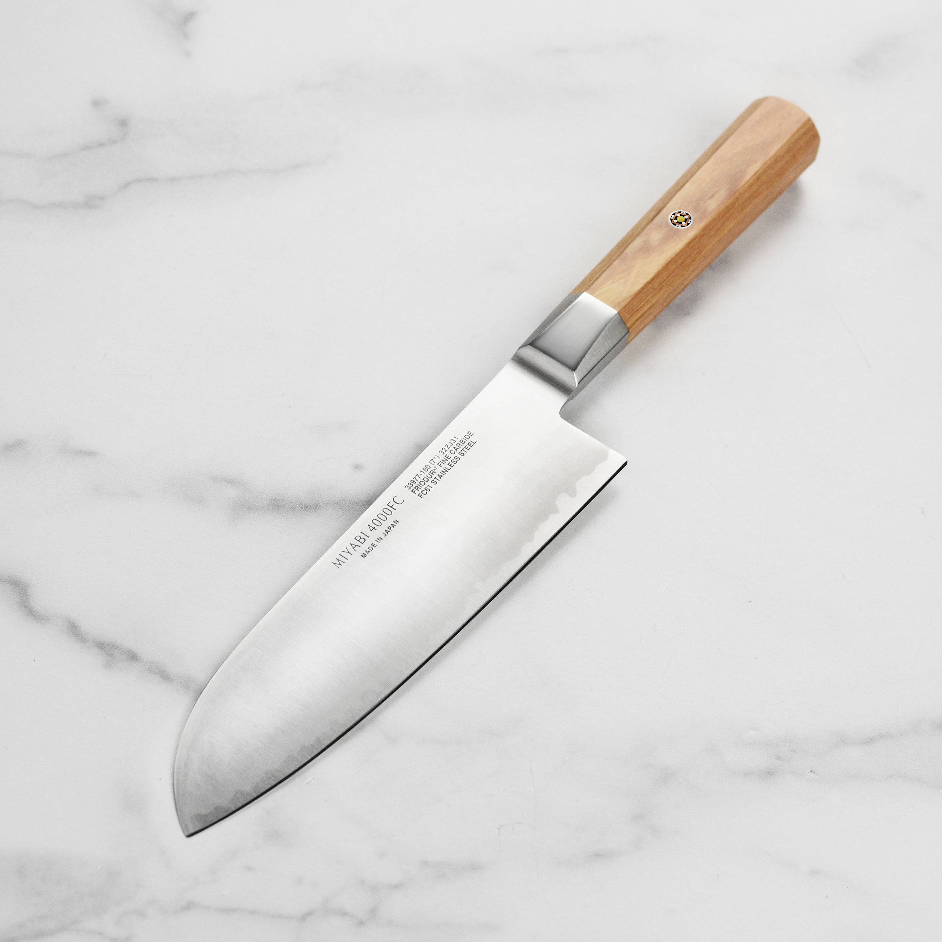 Close-up of Miyabi Koya 7 inch santoku knife blade with engraved logo and Katana edge
