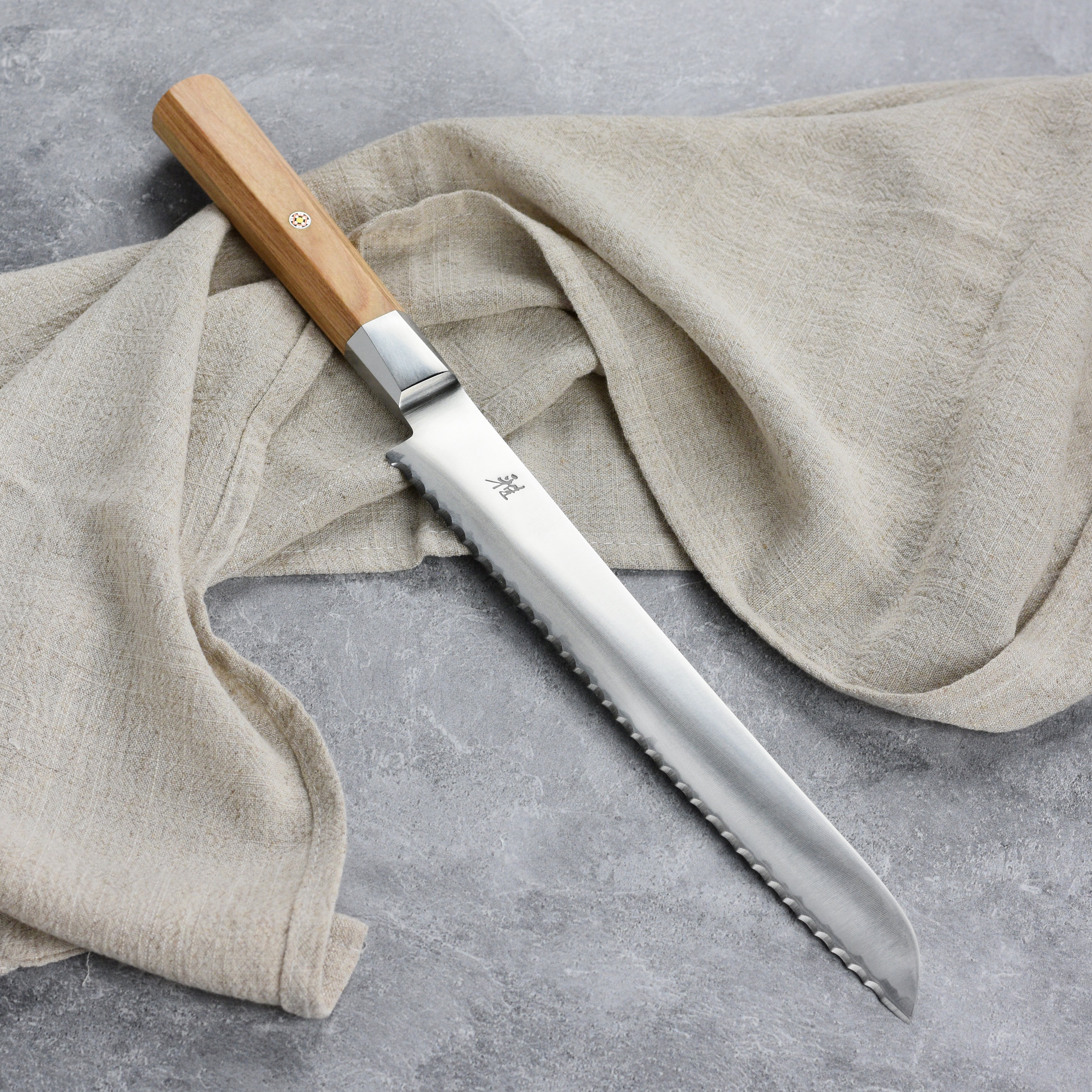 Styled shot of the magnetic knife set mounted on a sleek magnetic strip above a cutting board.