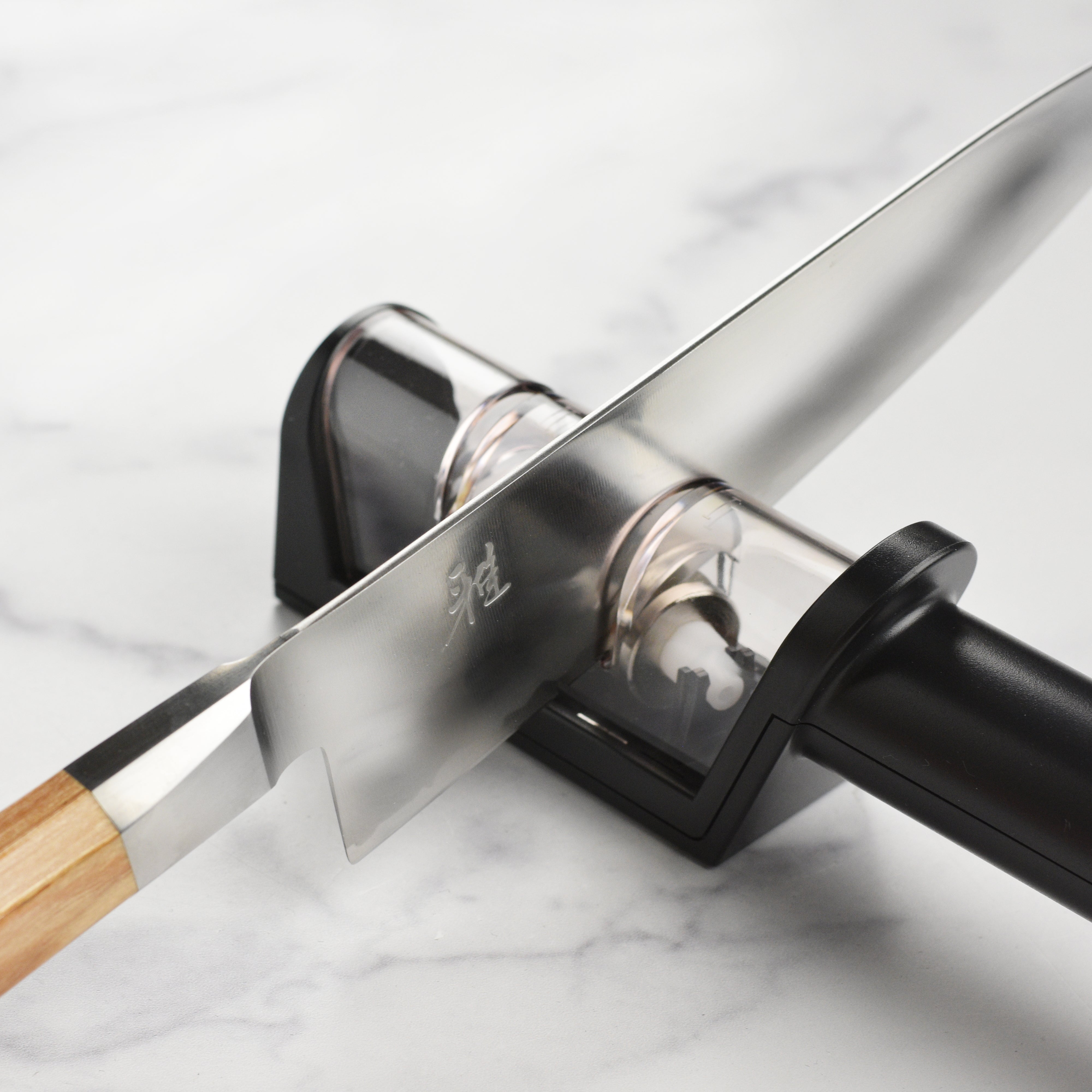 Miyabi Koya knife set with elegant birchwood handles, displayed on a wooden cutting board.