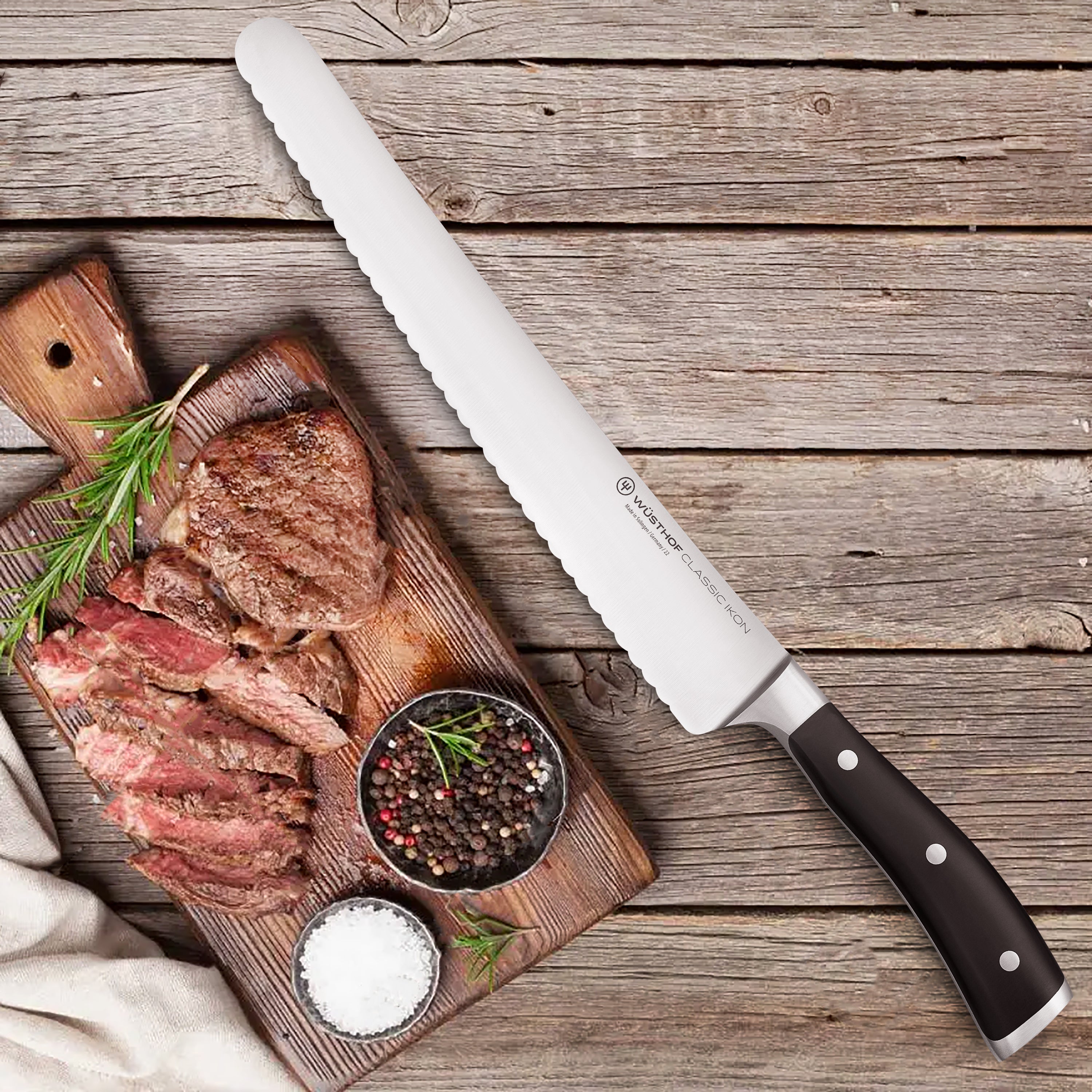 Wusthof Classic Ikon 10" High-Carbon Kitchen Slicer in action, effortlessly slicing through vegetables on a cutting board.
