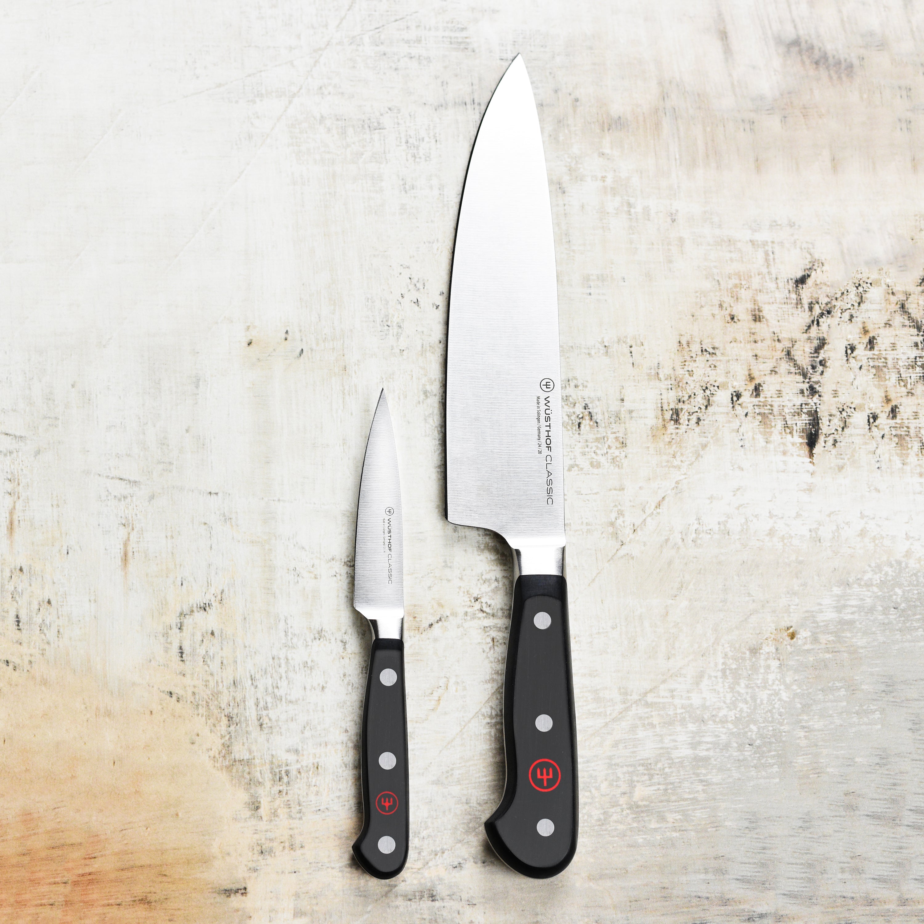 Close-up of Wusthof Classic chef knife with demi bolster, showing sharp blade and ergonomic handle