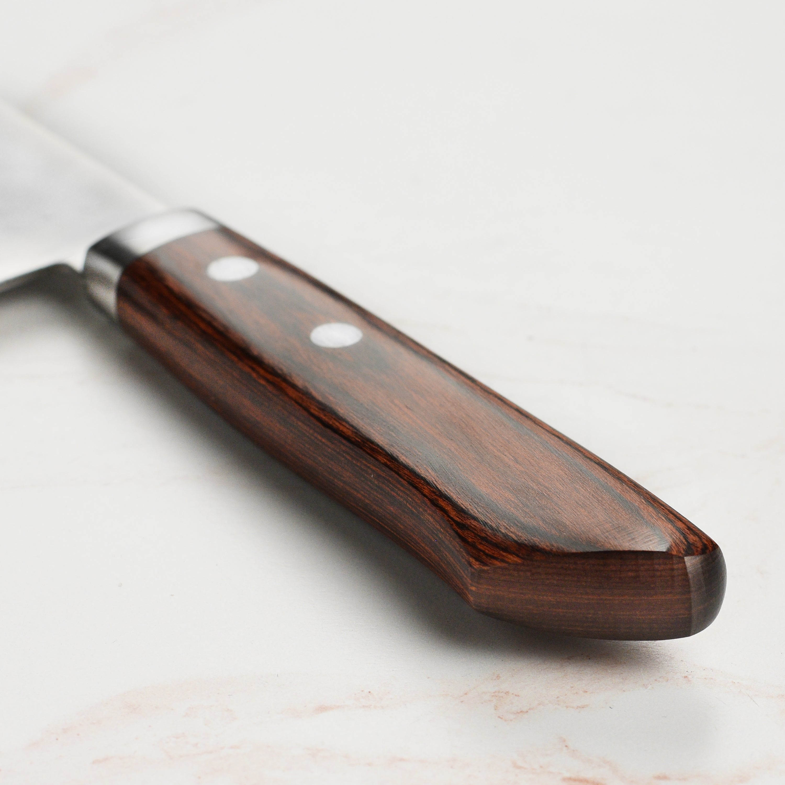 Close-up of the hammered tsuchime finish on the Nakiri blade, highlighting craftsmanship