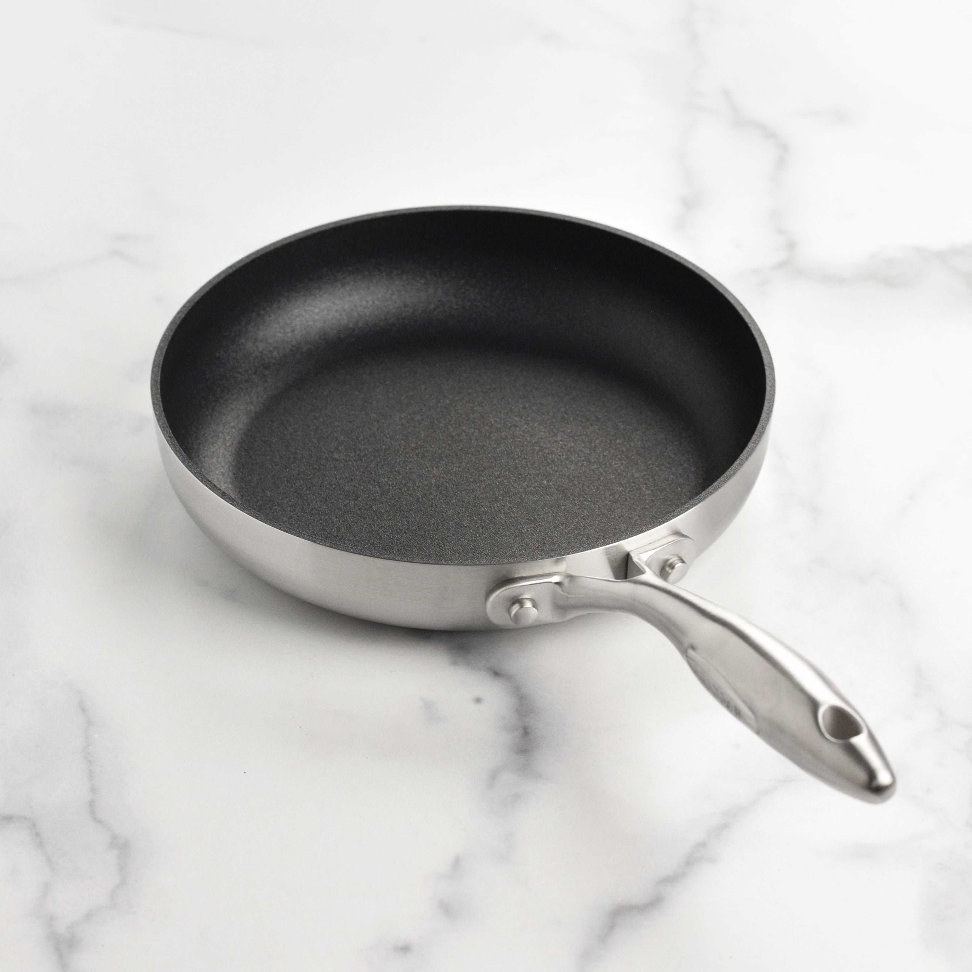 Cooking with the Scanpan CX+ nonstick fry pan, demonstrating its even heat distribution