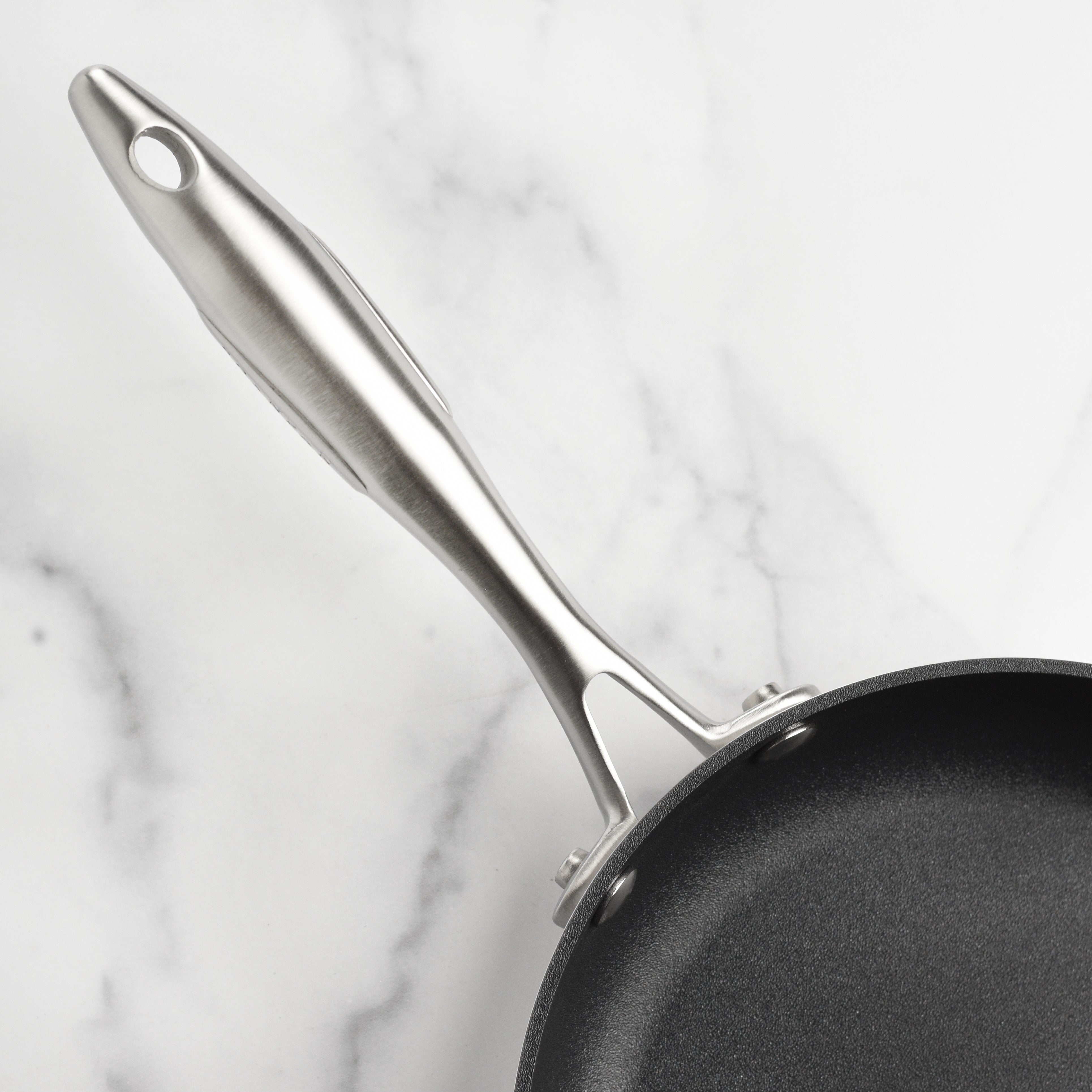 Close-up of Scanpan CX+ stainless steel nonstick fry pan highlighting the durable coating and sleek design