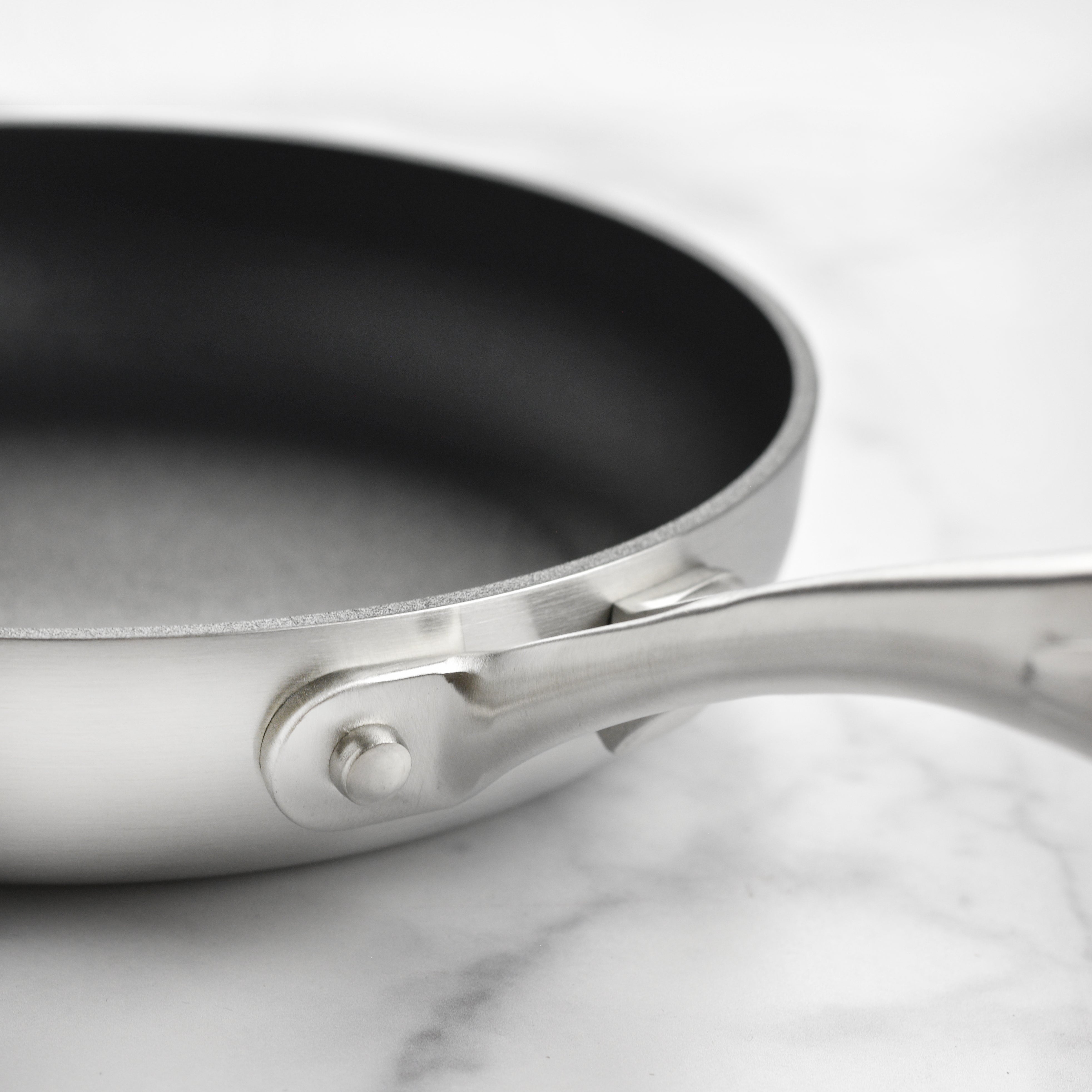 Stacked stainless steel cookware set showcasing the versatile and durable pans