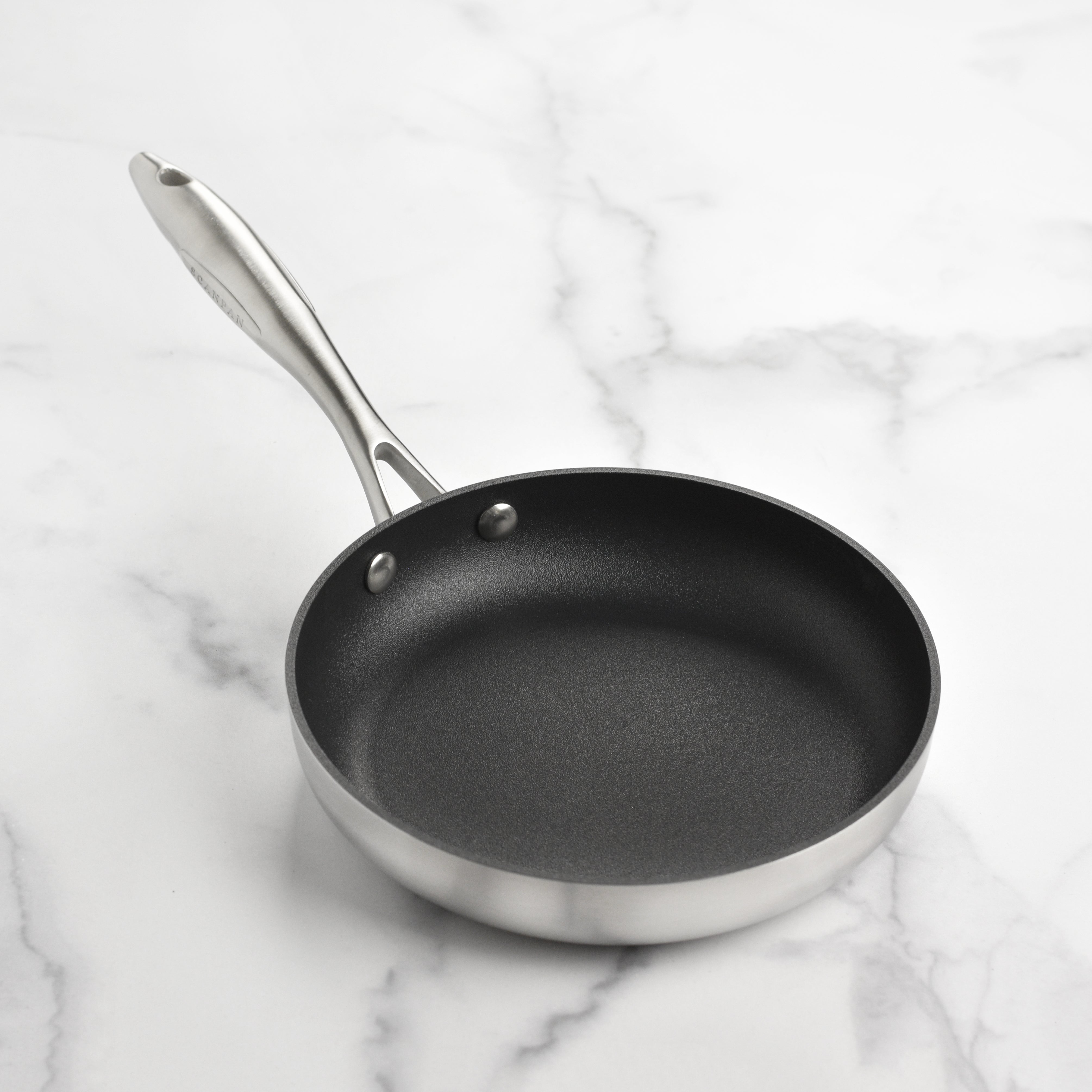 Close-up of the nonstick surface of Scanpan CX+ fry pan, highlighting its durability and design