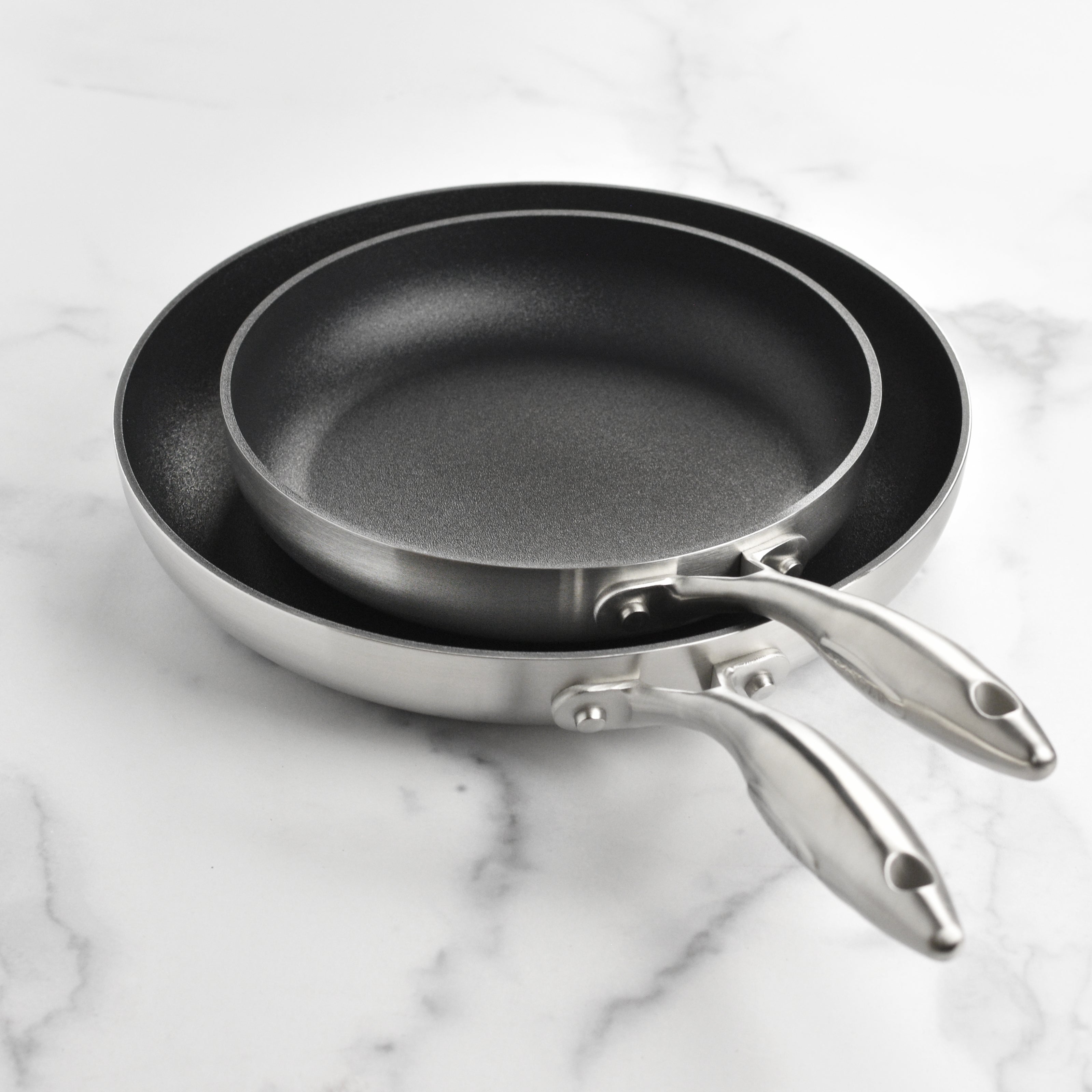 Chef using the nonstick fry pan on induction cooktop for sautéing vegetables