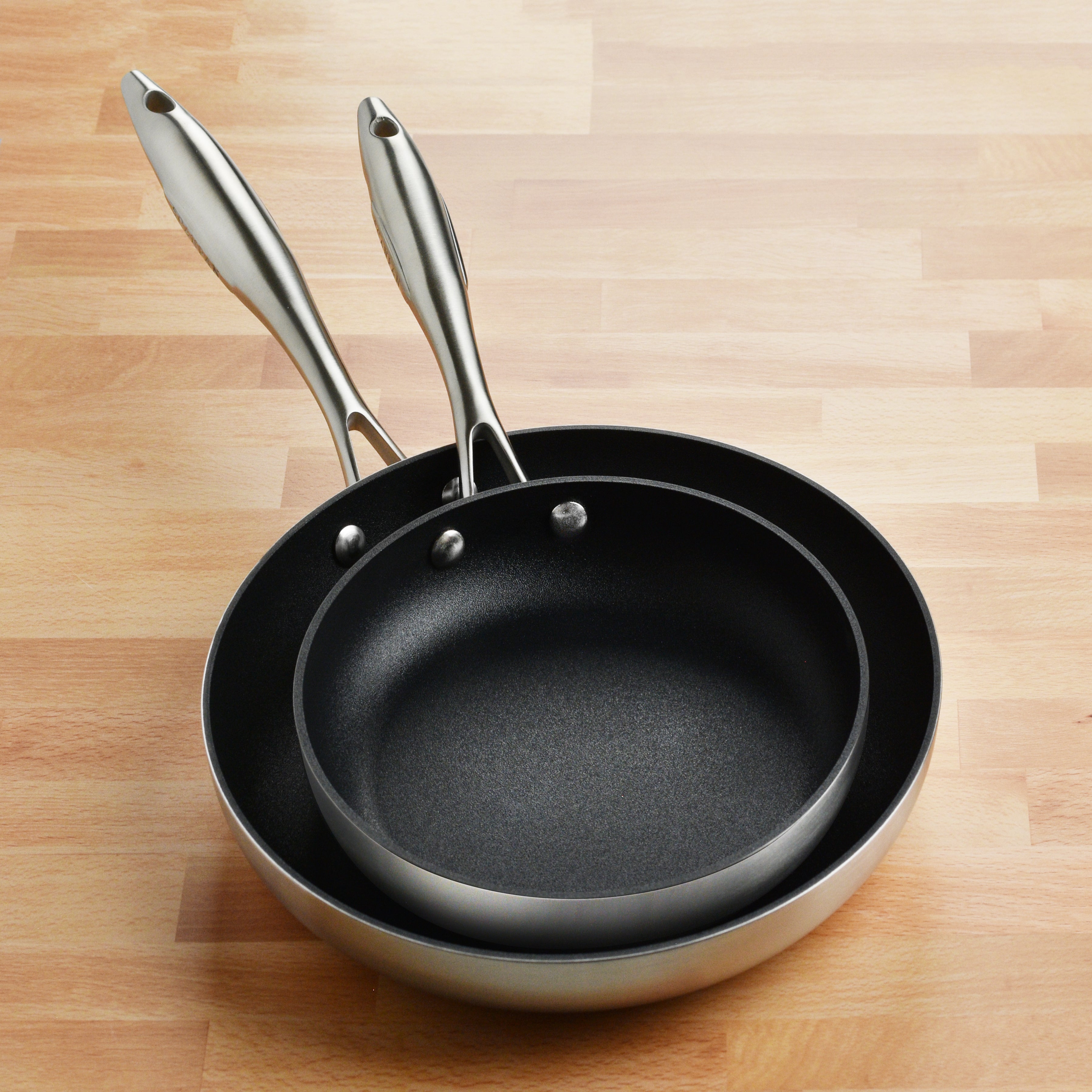 Stacked stainless steel cookware set showcasing the versatile and durable pans