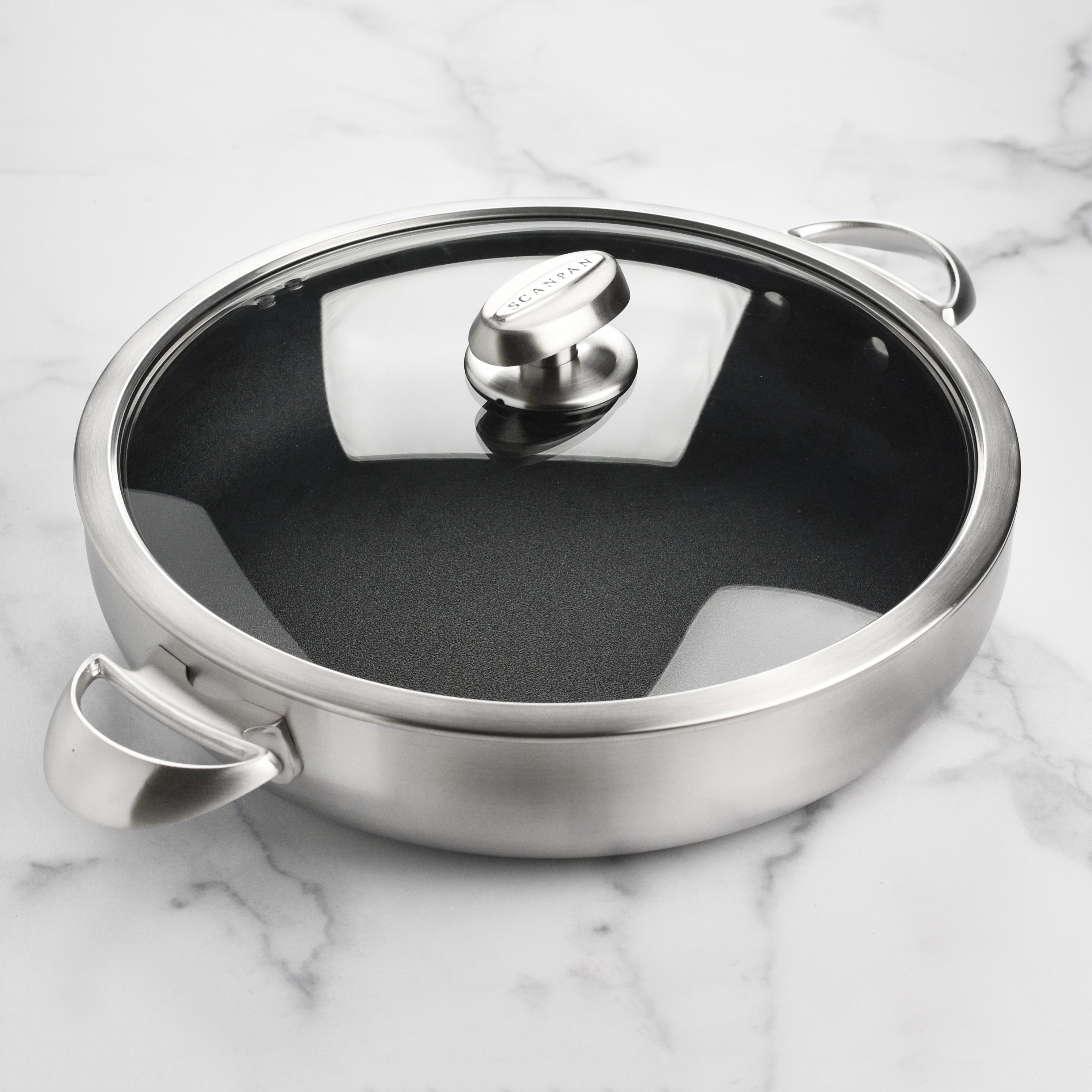 Overhead shot of the kitchen braiser in action, simmering a delicious stew with a glass lid visible.
