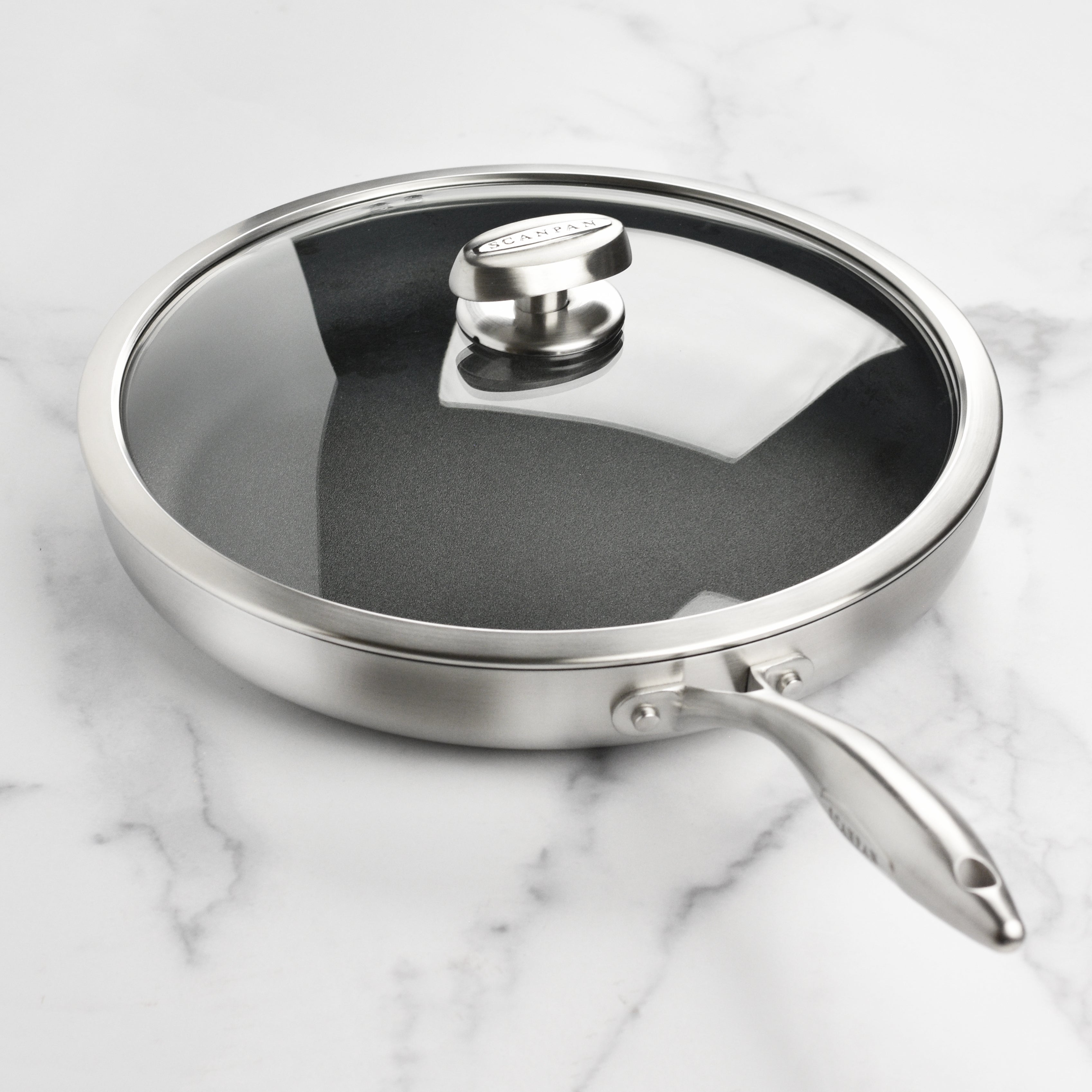 Cast stainless steel handle on nonstick fry pan with lid for safe handling