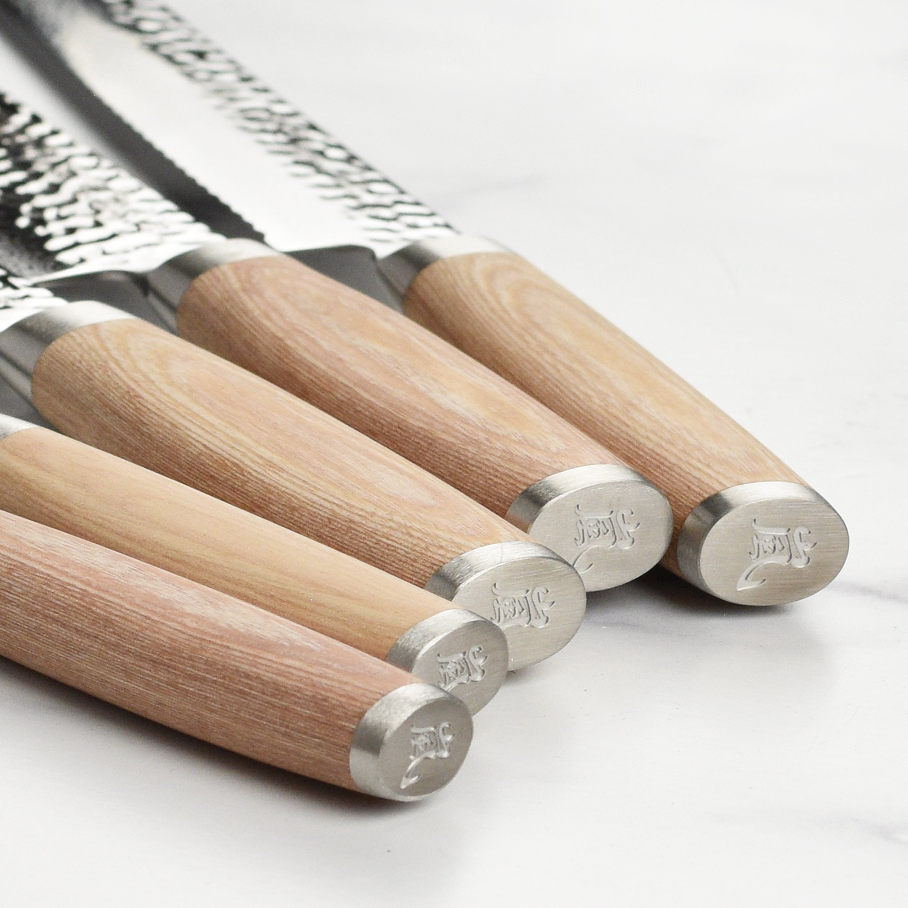 Premium Damascus chef knife block set showcasing the beautiful hammered finish and elegant design.