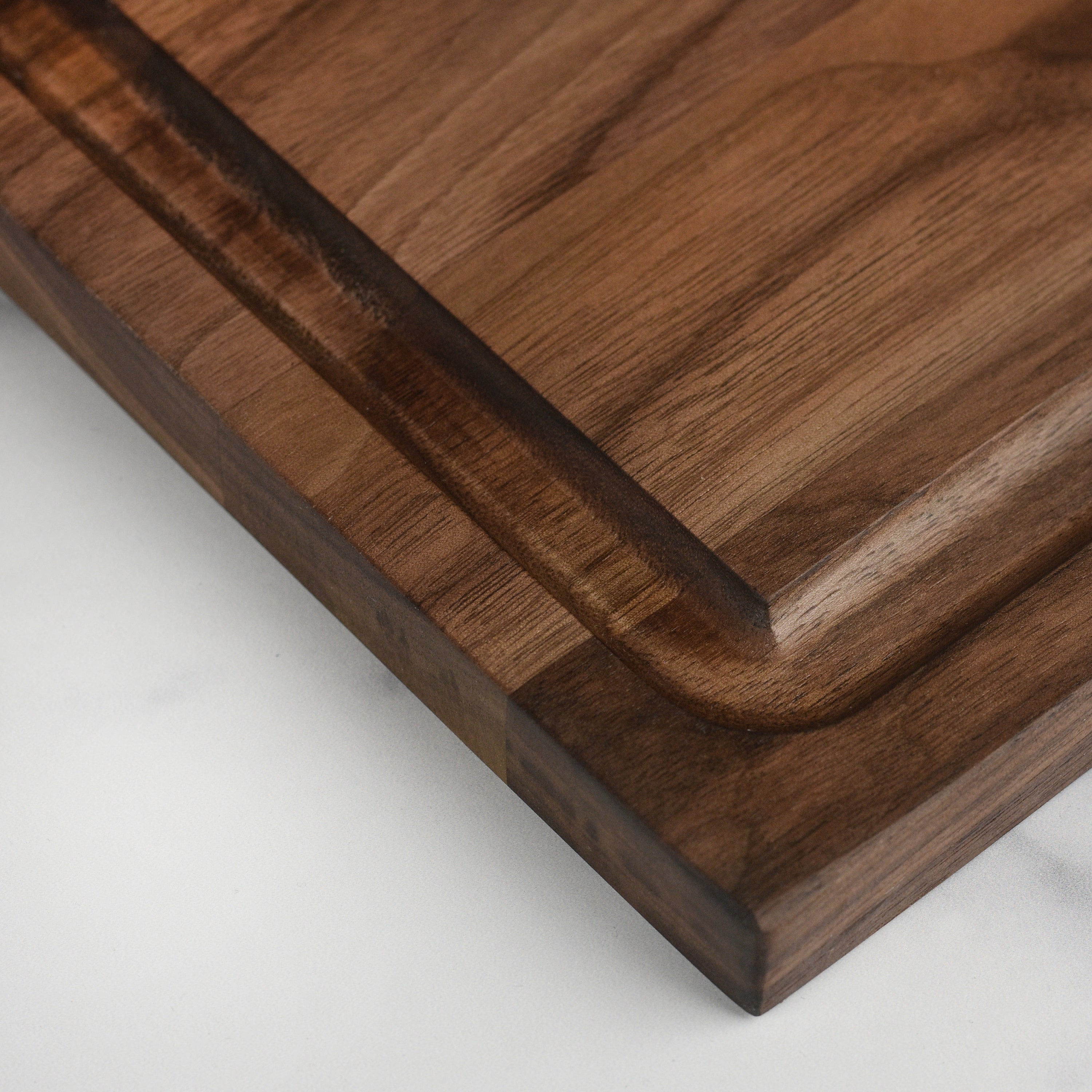 Close-up of the walnut board highlighting the intricate block layout and finish.