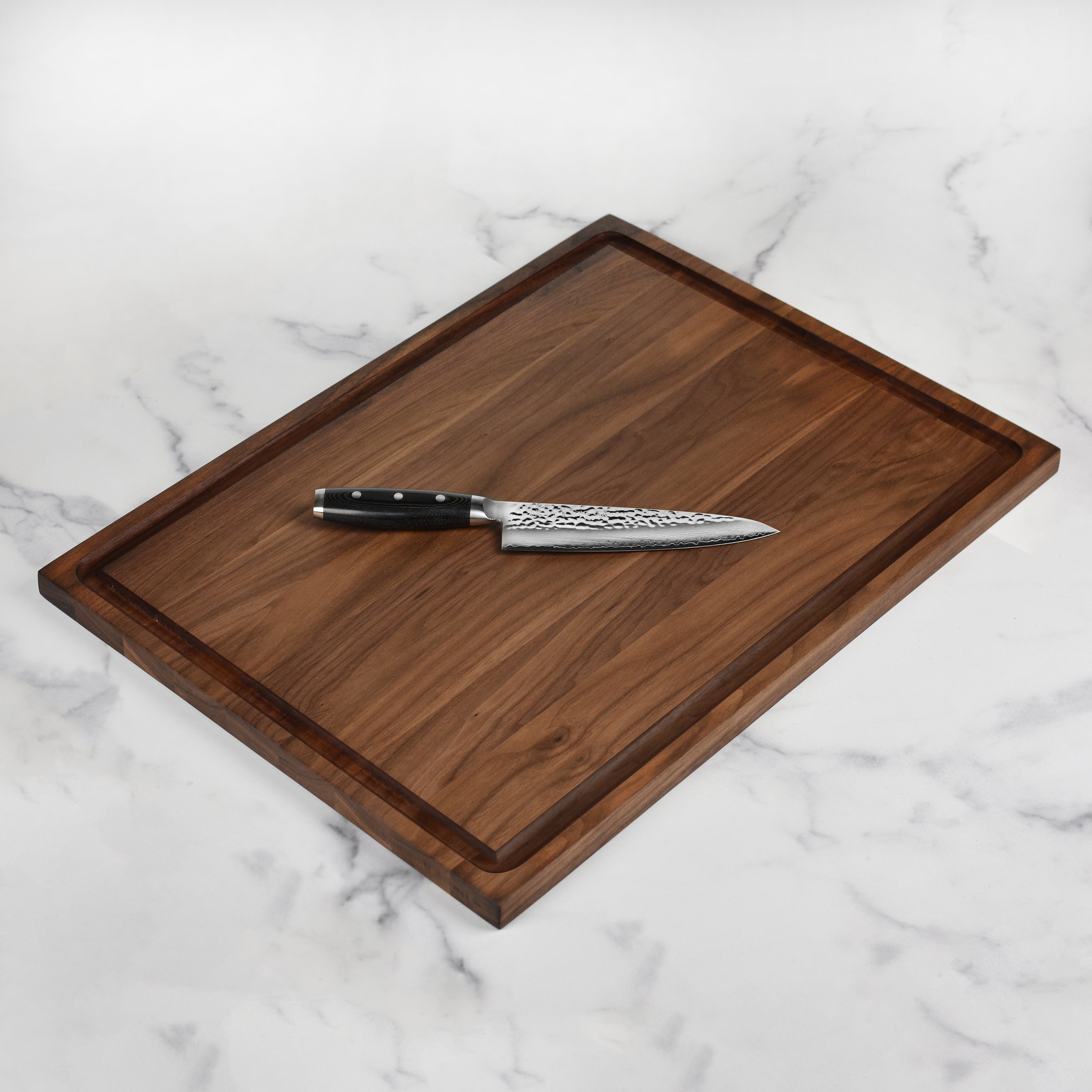 Artisan walnut cutting board set showcasing its rich grain and craftsmanship.