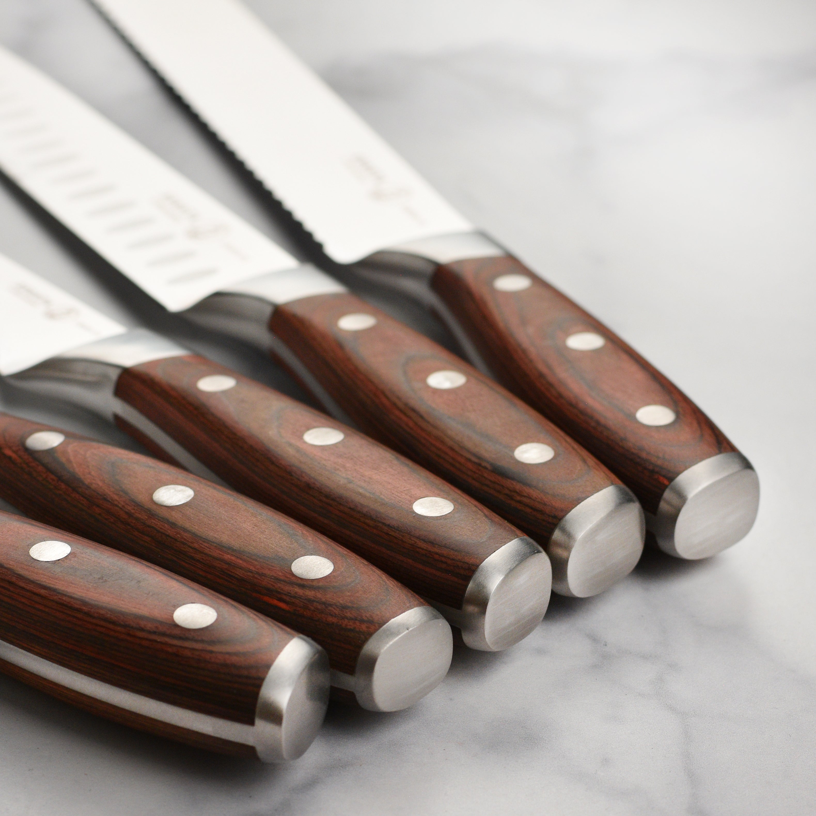 Close-up of the high carbon stainless steel blade from the BBQ knife set, showcasing its sharp edge and craftsmanship.
