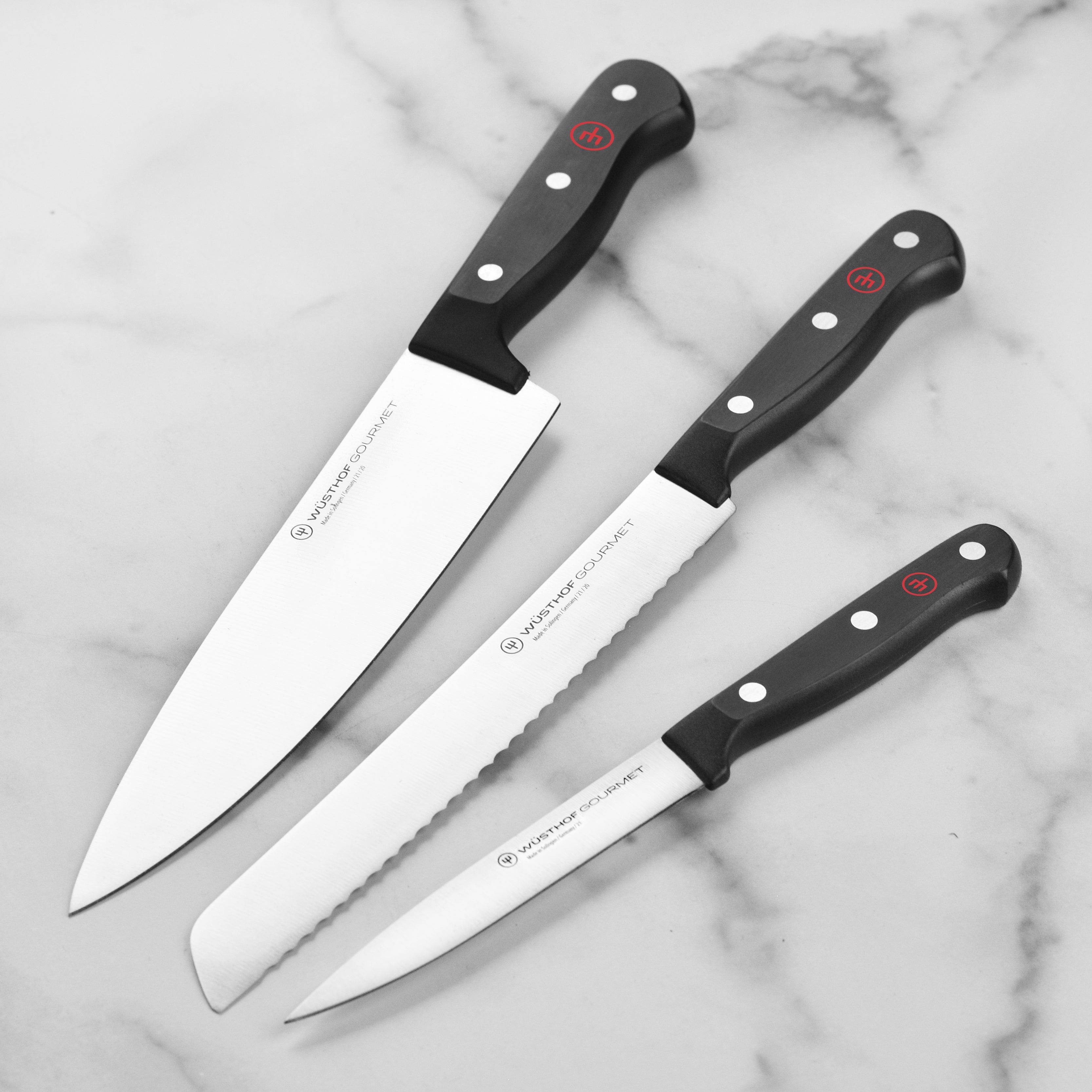 Wusthof Gourmet knife set displayed on a wooden cutting board, highlighting the sharp blades and ergonomic design.