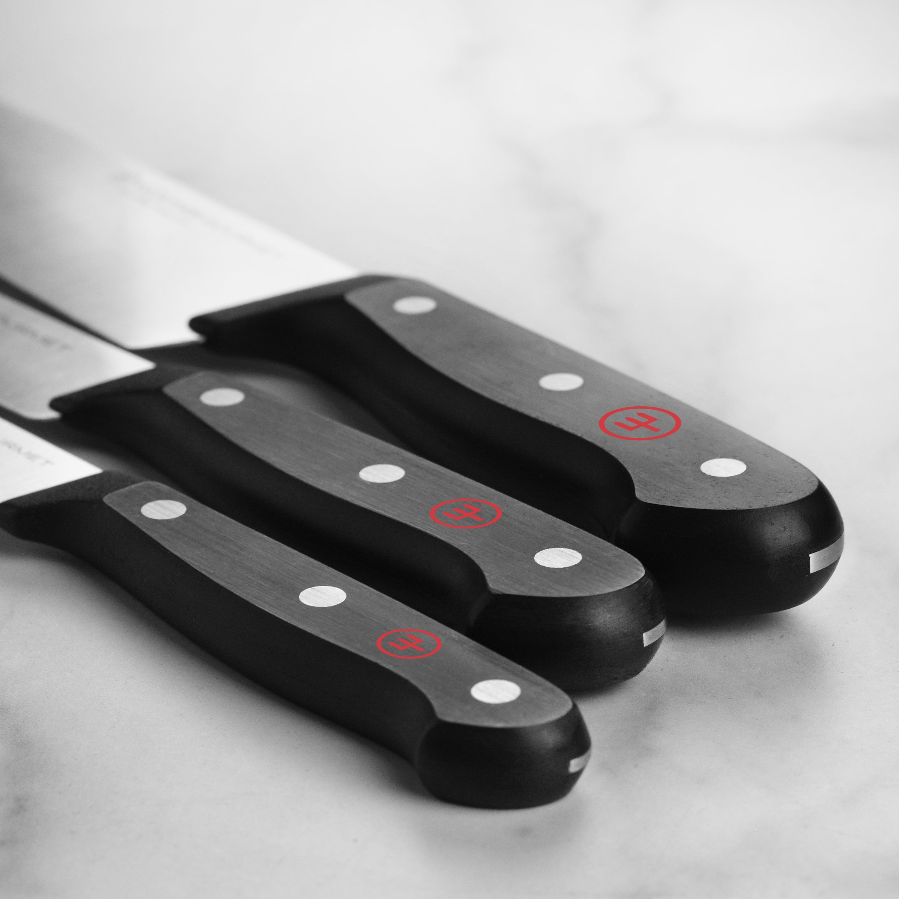 Close-up view of the Wusthof chef knife in action, slicing fresh vegetables with precision.