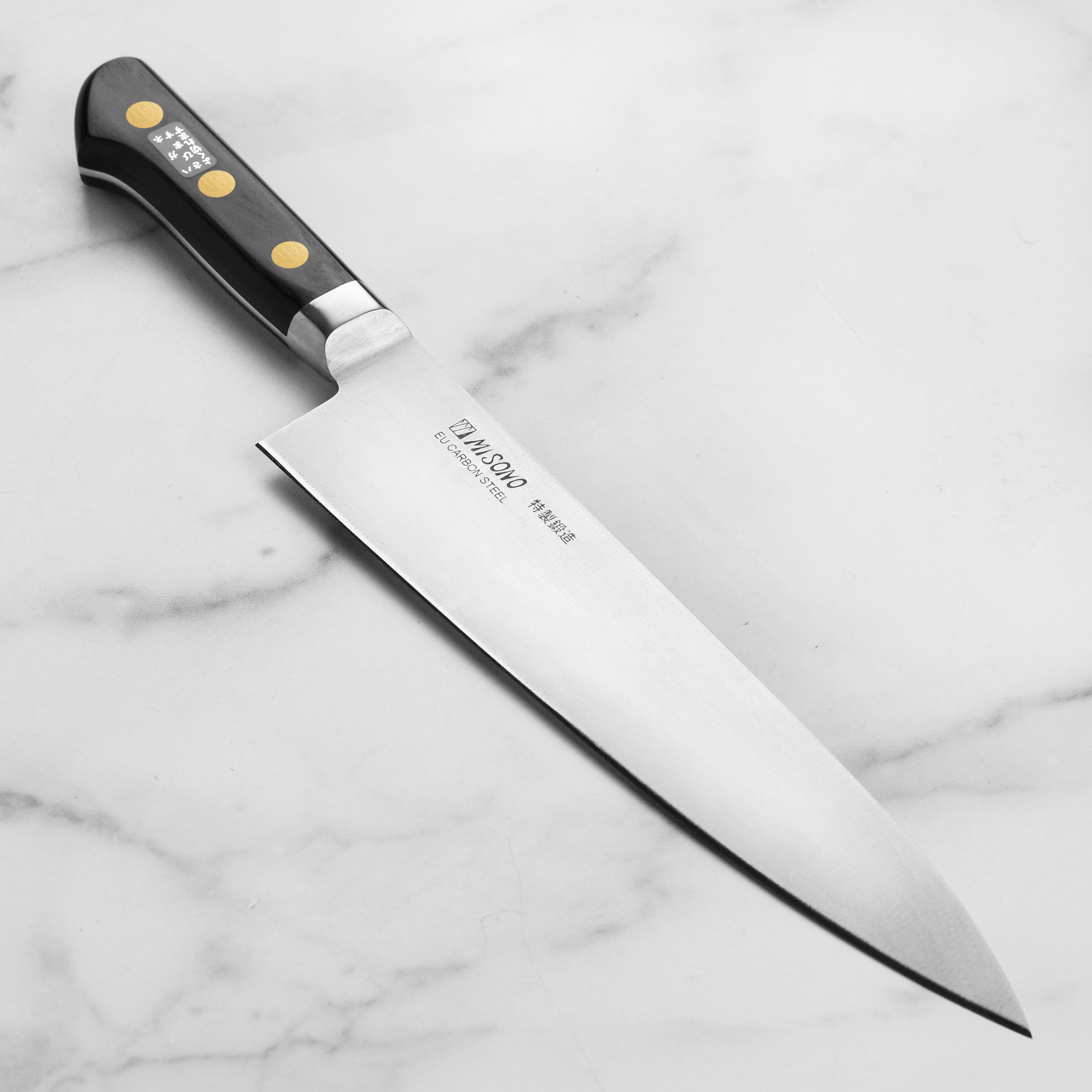 Close-up of the hand-forged carbon steel blade with a sharp edge